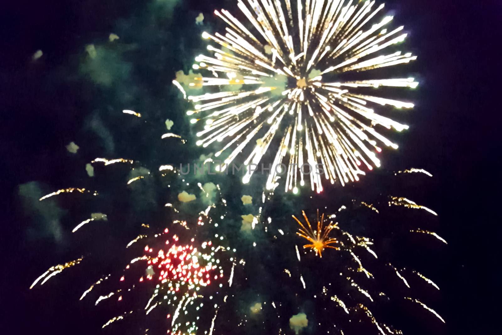 Festive salute in the night sky. Explosions of fireworks.