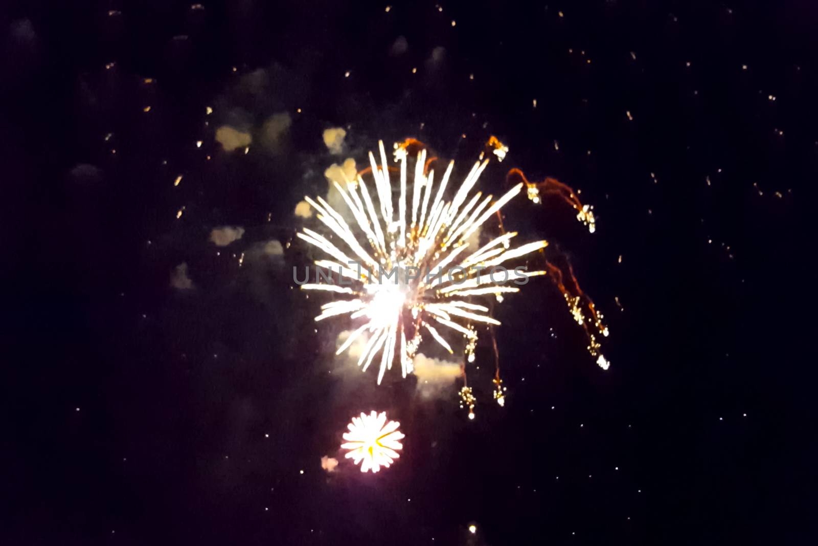 Festive salute in the night sky. Explosions of fireworks.