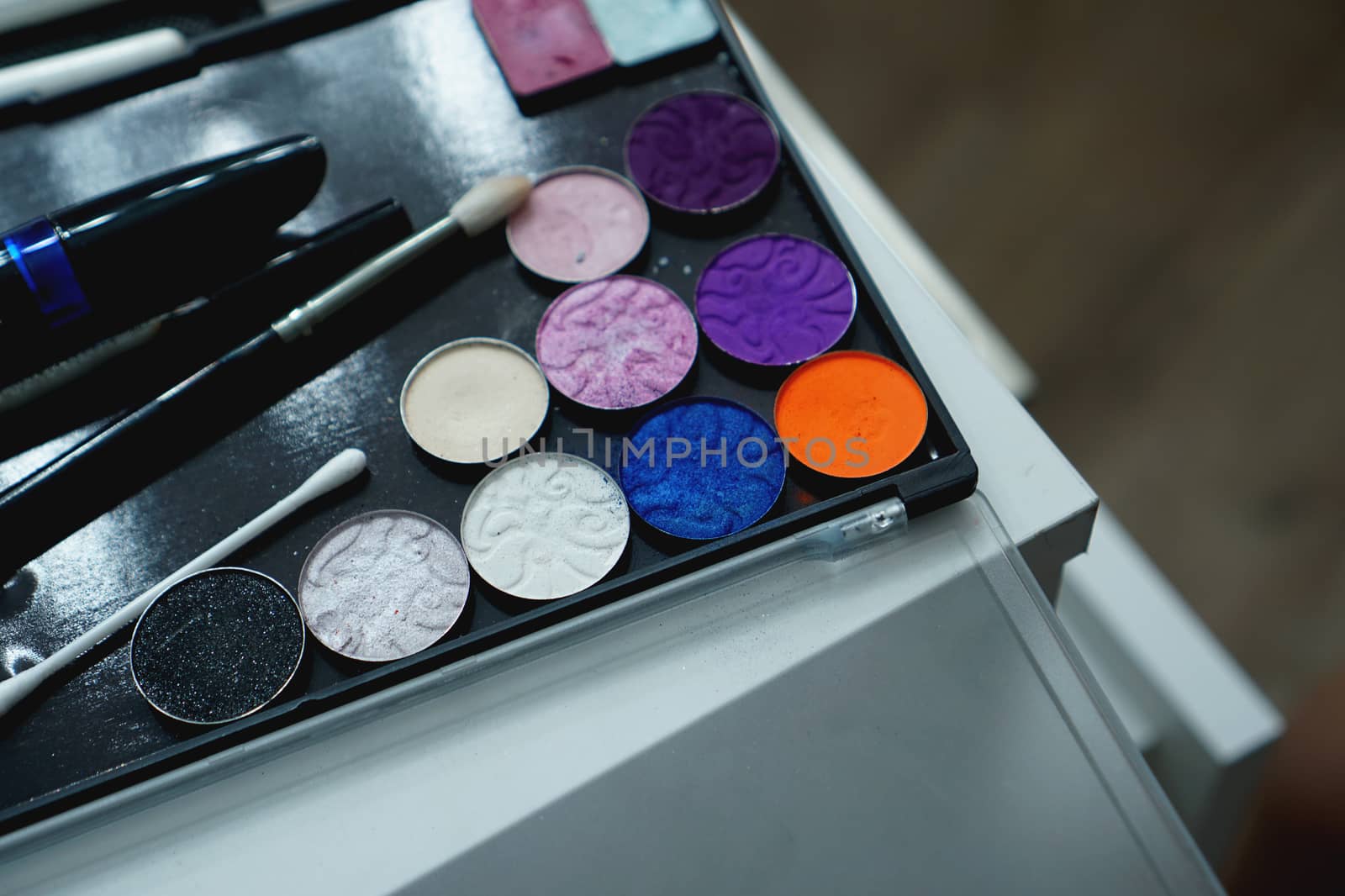 Palette of shadows for makeup on a blurred background, closeup by natali_brill