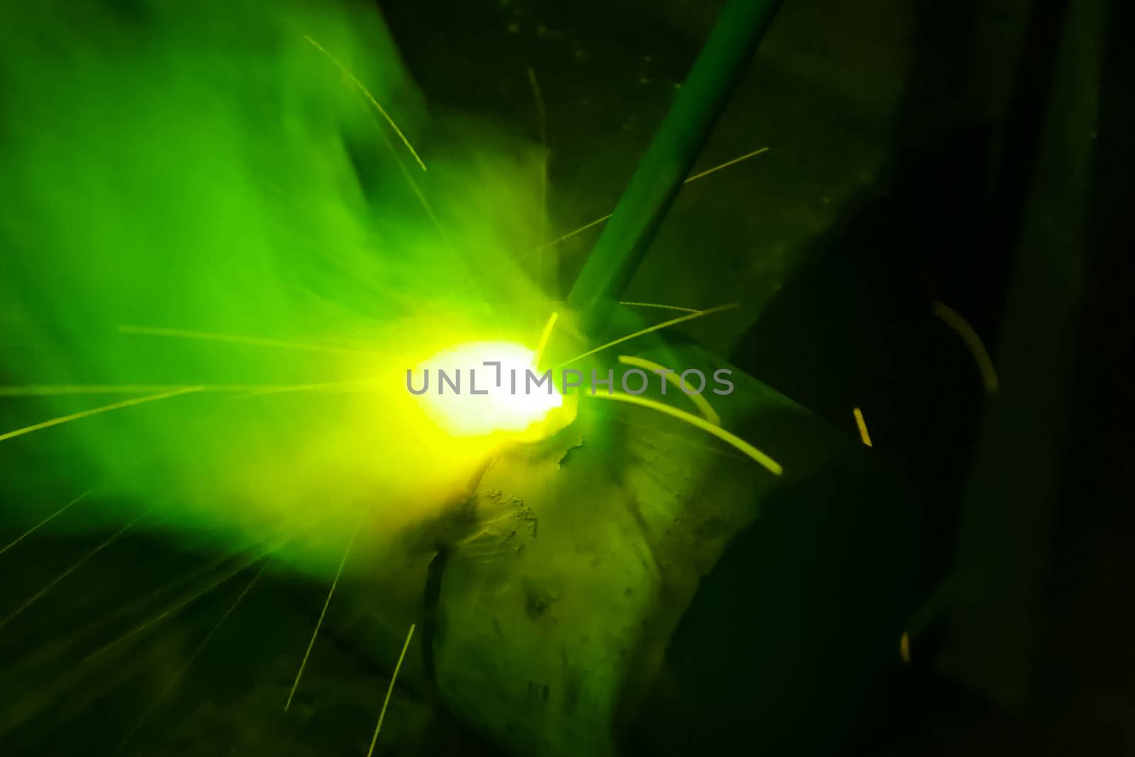 Metal pipe during welding. Sparks and scale.