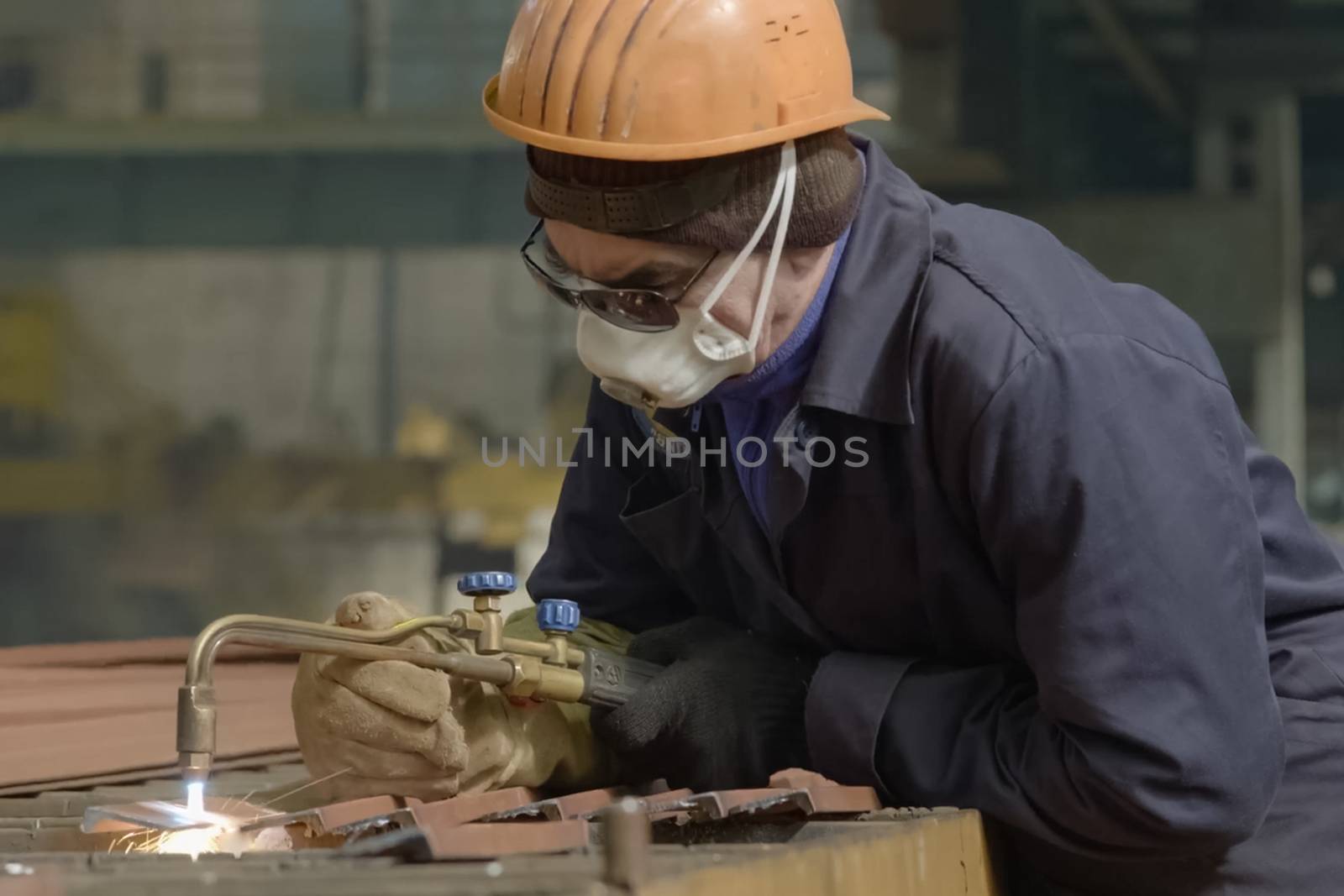 The welder cuts the metal with gas welding. by nyrok