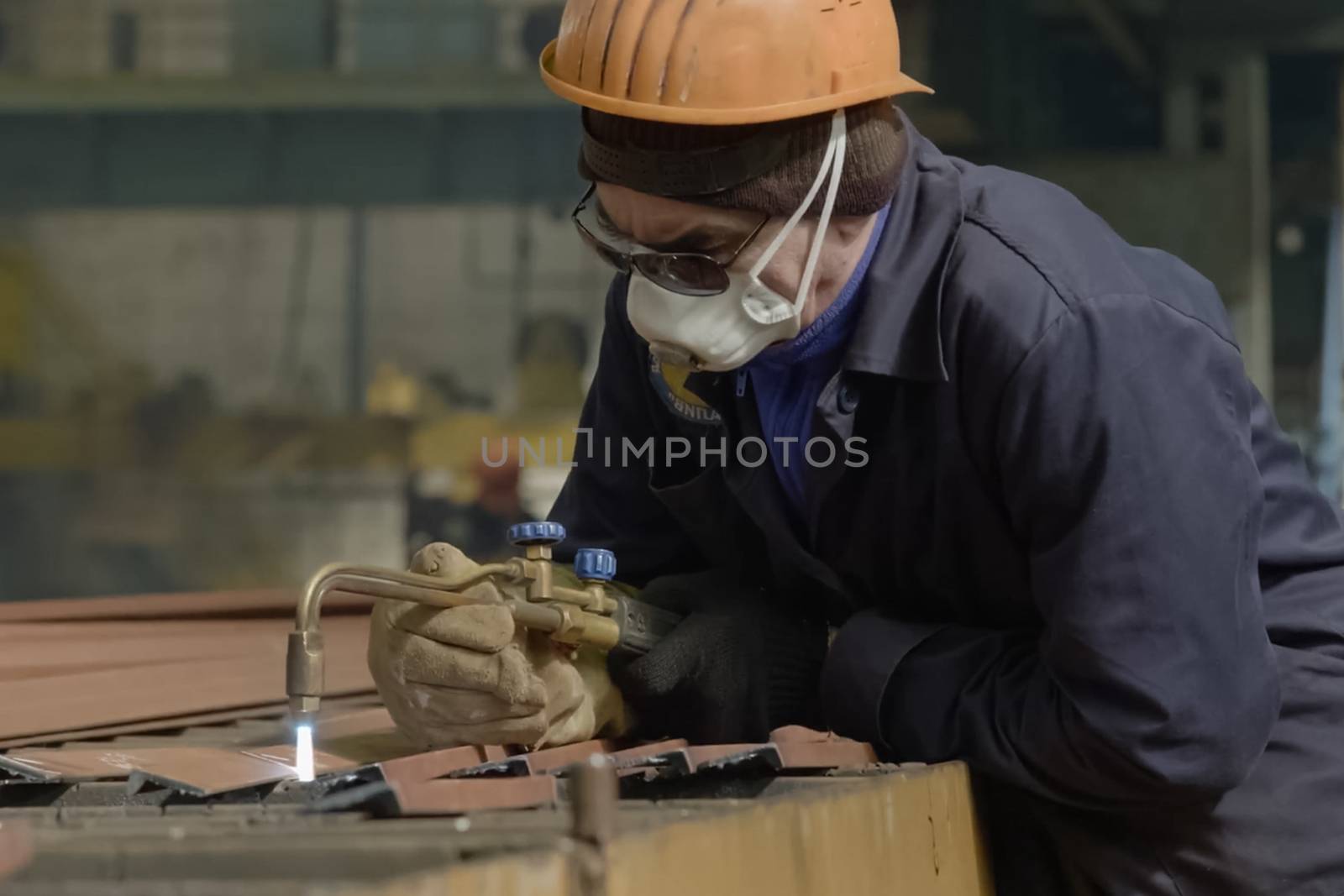 Novorossiysk, Russia - May 26, 2018: Shipbuilding plant, The welder cuts the metal with gas welding.