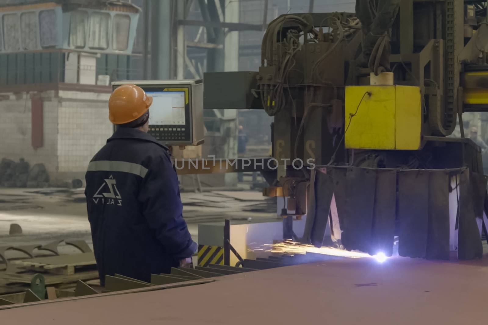 Novorossiysk, Russia - May 26, 2018: The worker welds the details with welding on the welding machine. Mechanization of welding.