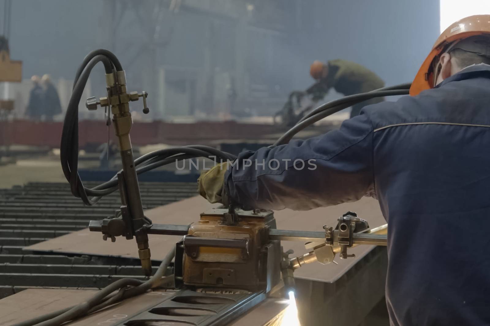 The worker welds the details with welding on the welding machine by nyrok