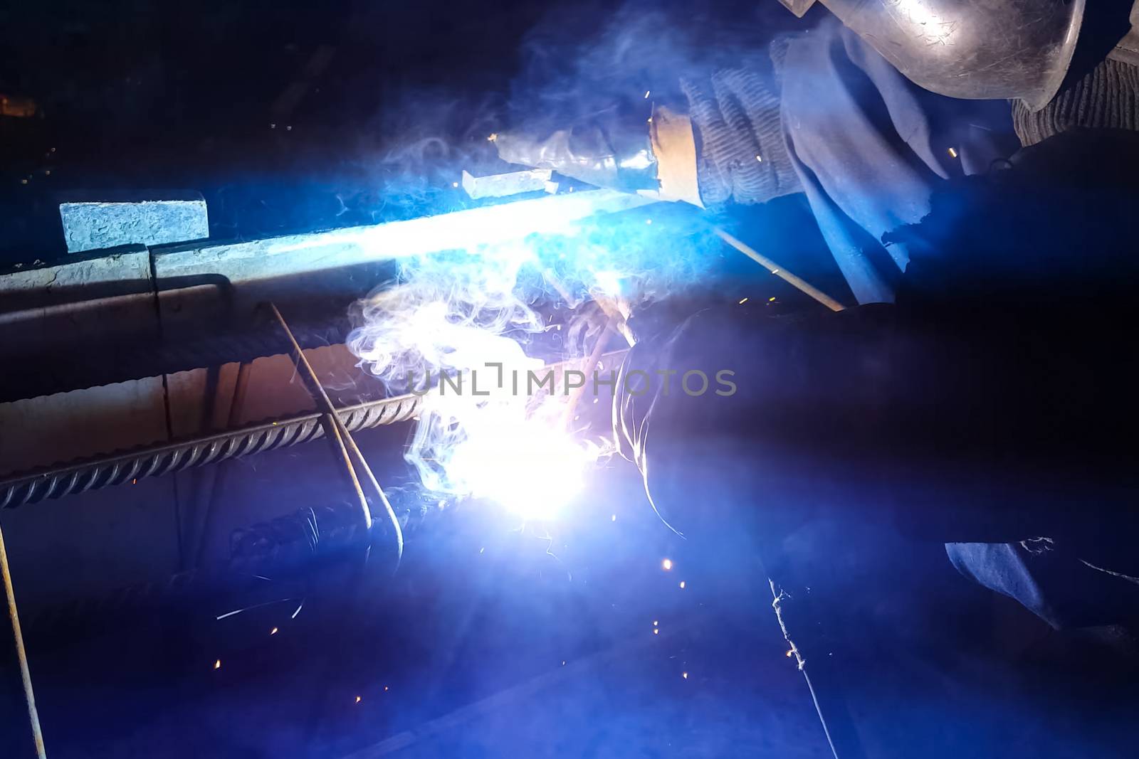 Welding of steel reinforcement. Sparks and light from welding. E by nyrok