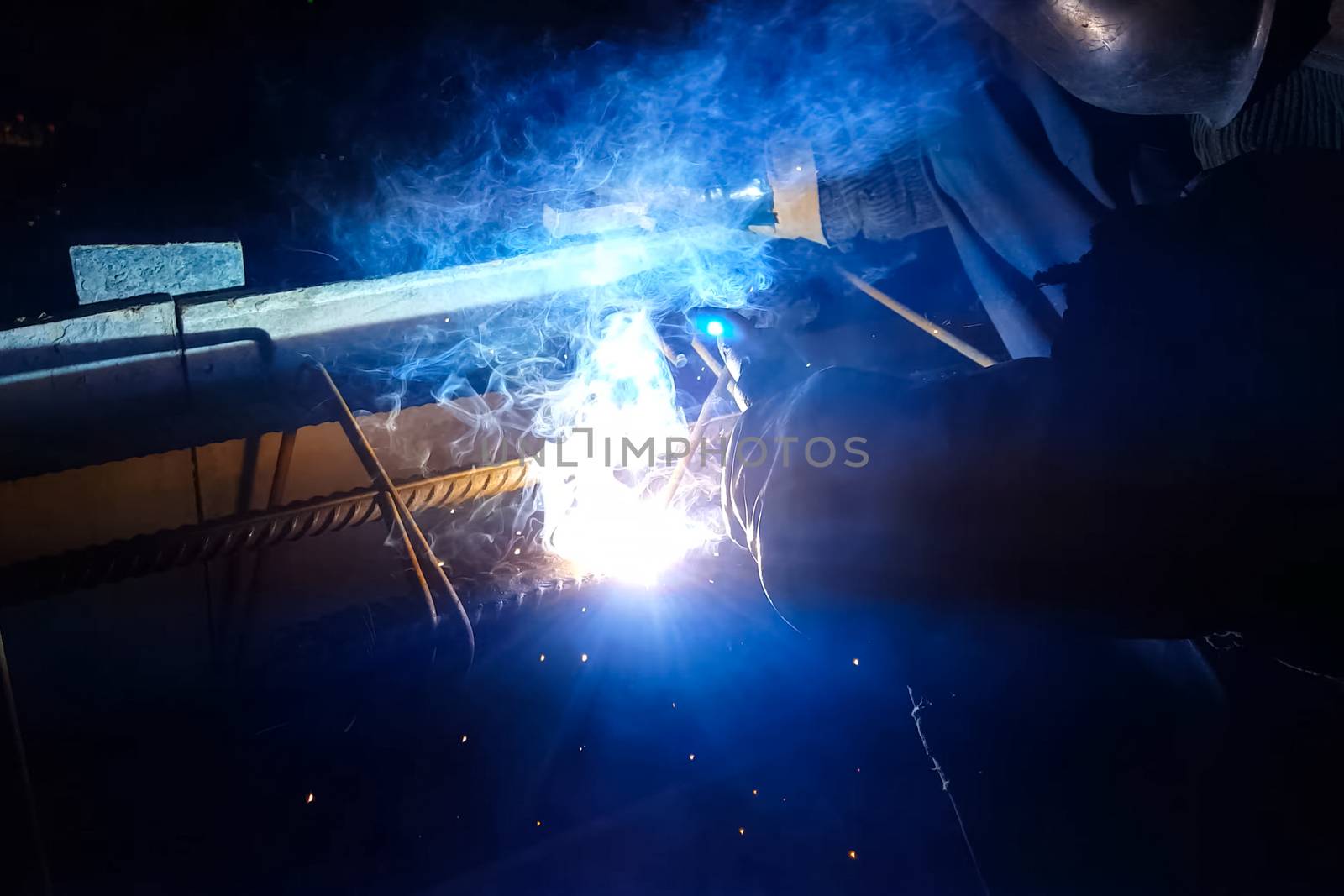 Welding of steel reinforcement. Sparks and light from welding. E by nyrok