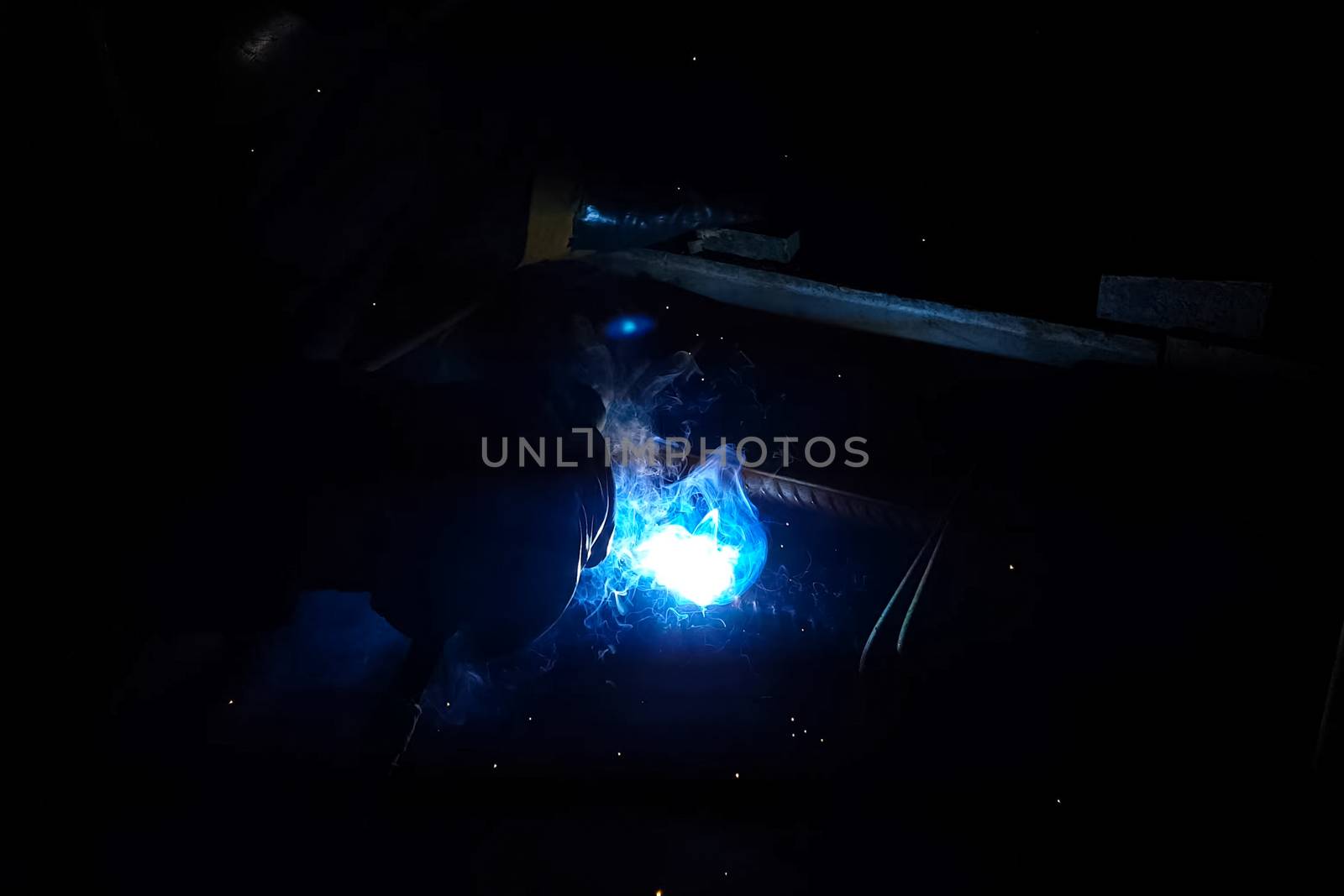 Welding of steel reinforcement. Sparks and light from welding. Electric welding.