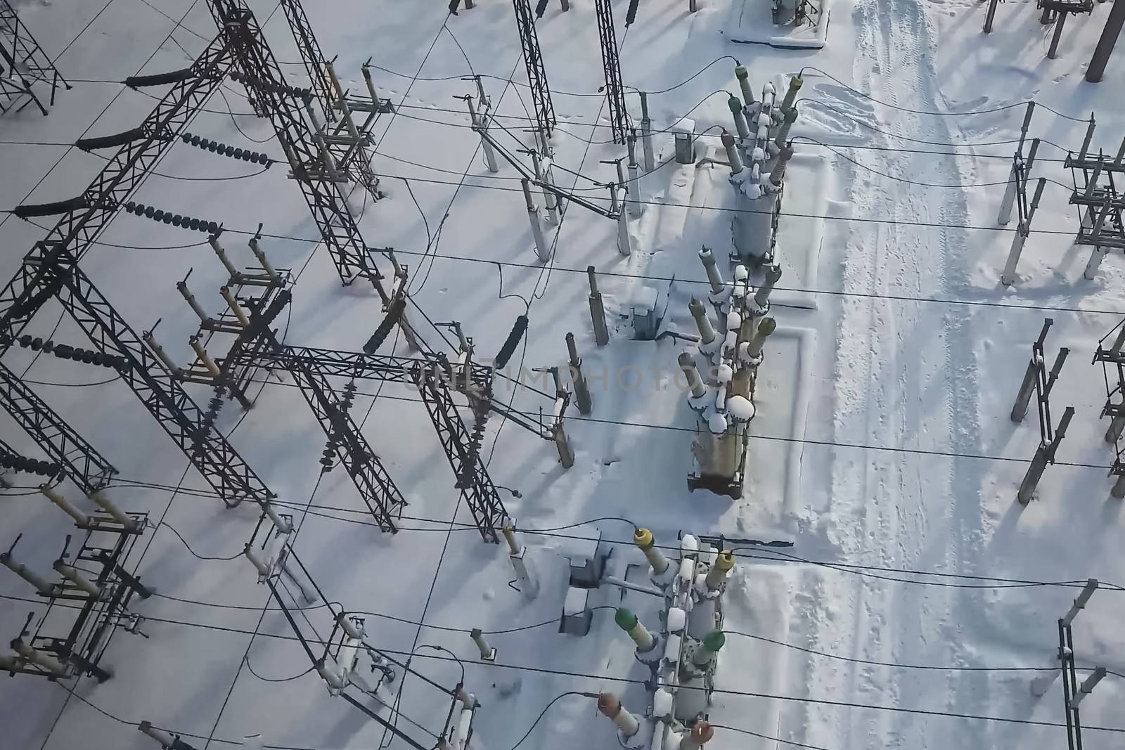 Electrical substation in the snow in winter. High voltage wires. by nyrok