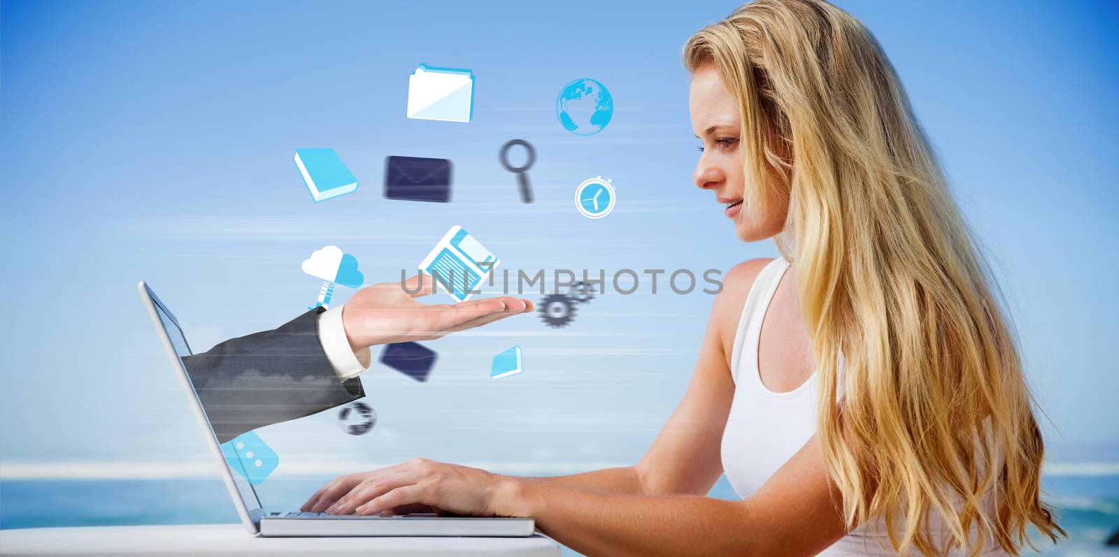 Composite image of pretty blonde using her laptop at the beach with hand presenting