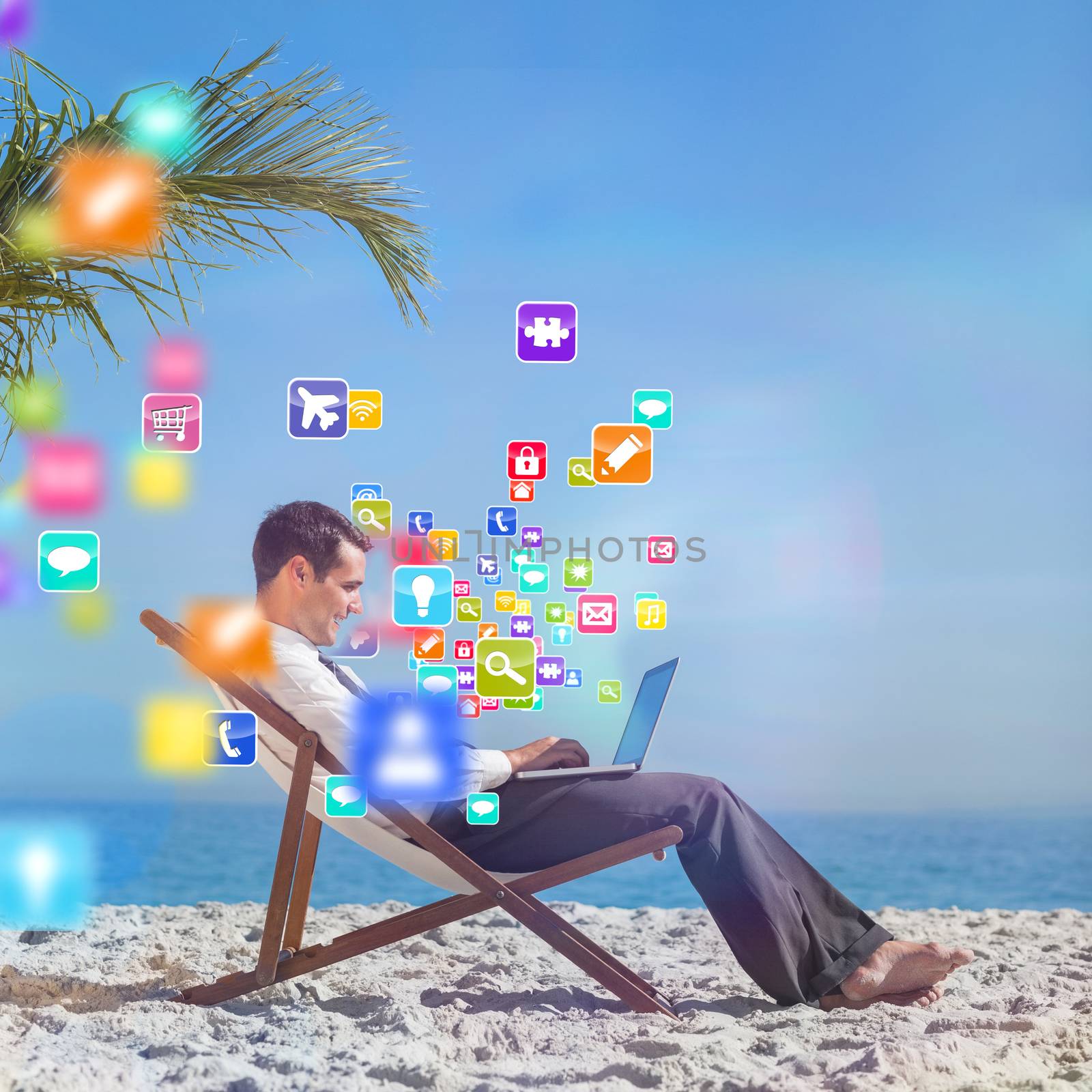 Young businessman on his beach chair using his laptop with colourful computer applications