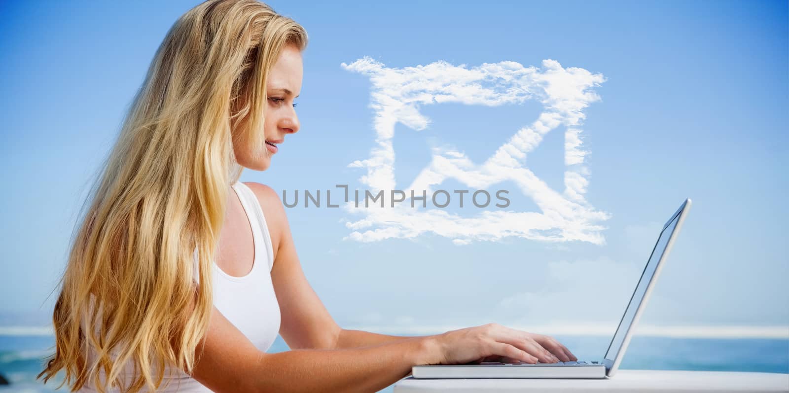 Composite image of pretty blonde using her laptop at the beach by Wavebreakmedia