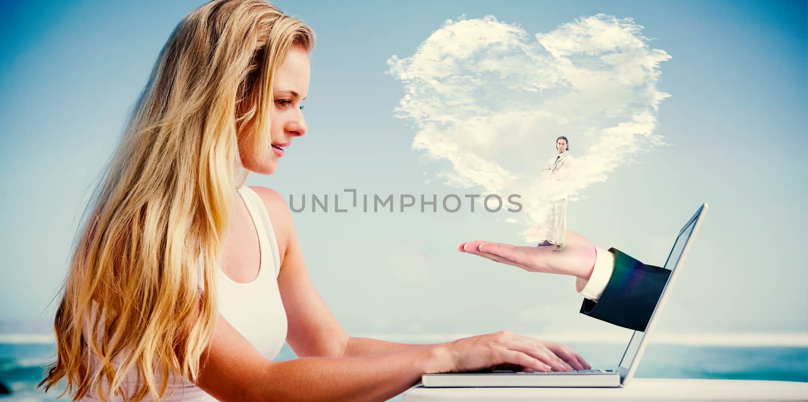 Composite image of pretty blonde using her laptop at the beach with heart cloud and hand