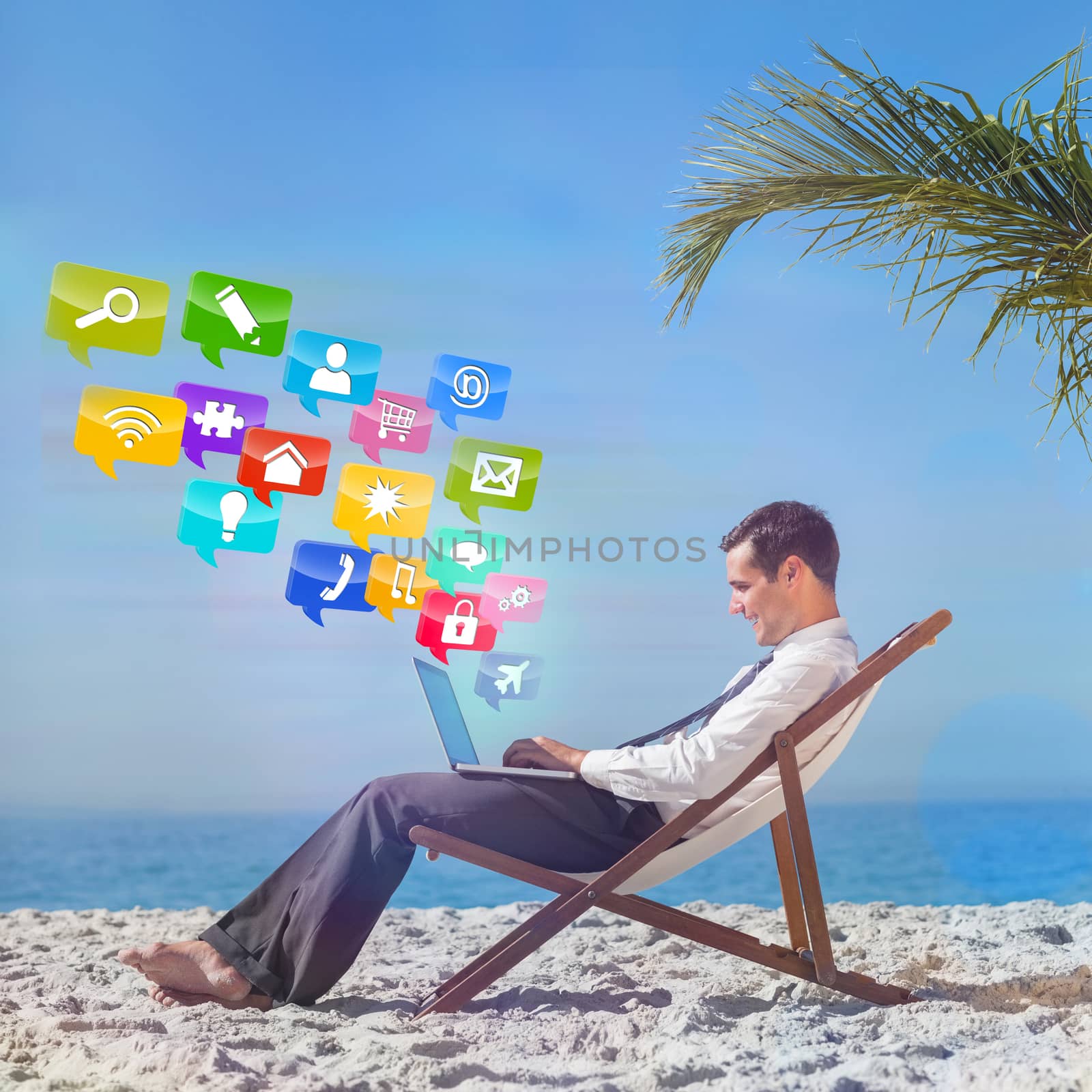 Young businessman on his beach chair using his laptop with colourful computer applications