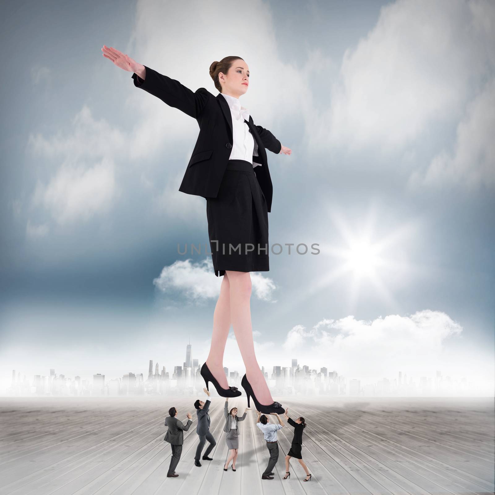 Composite image of business team supporting boss by Wavebreakmedia