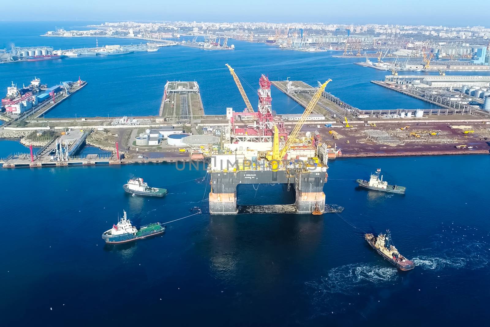 Drilling platform in the port. Towing of the oil platform.