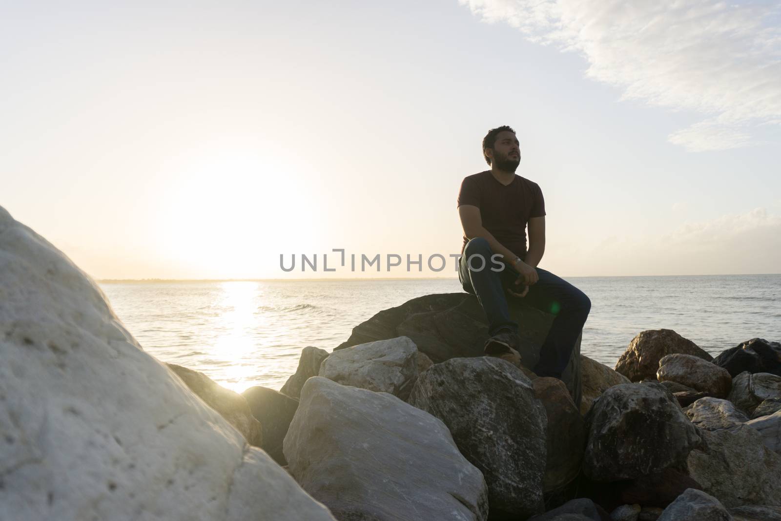 Man sitting on the rocks enjoying the sea view by henrry08