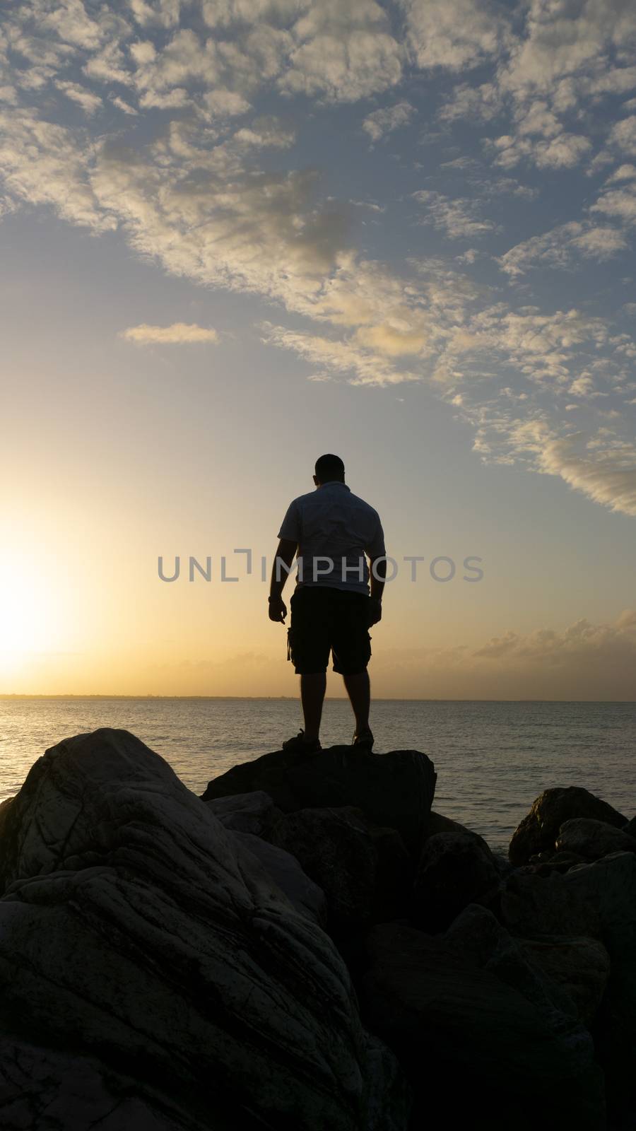 Man standing on the rocks enjoying the ocean view