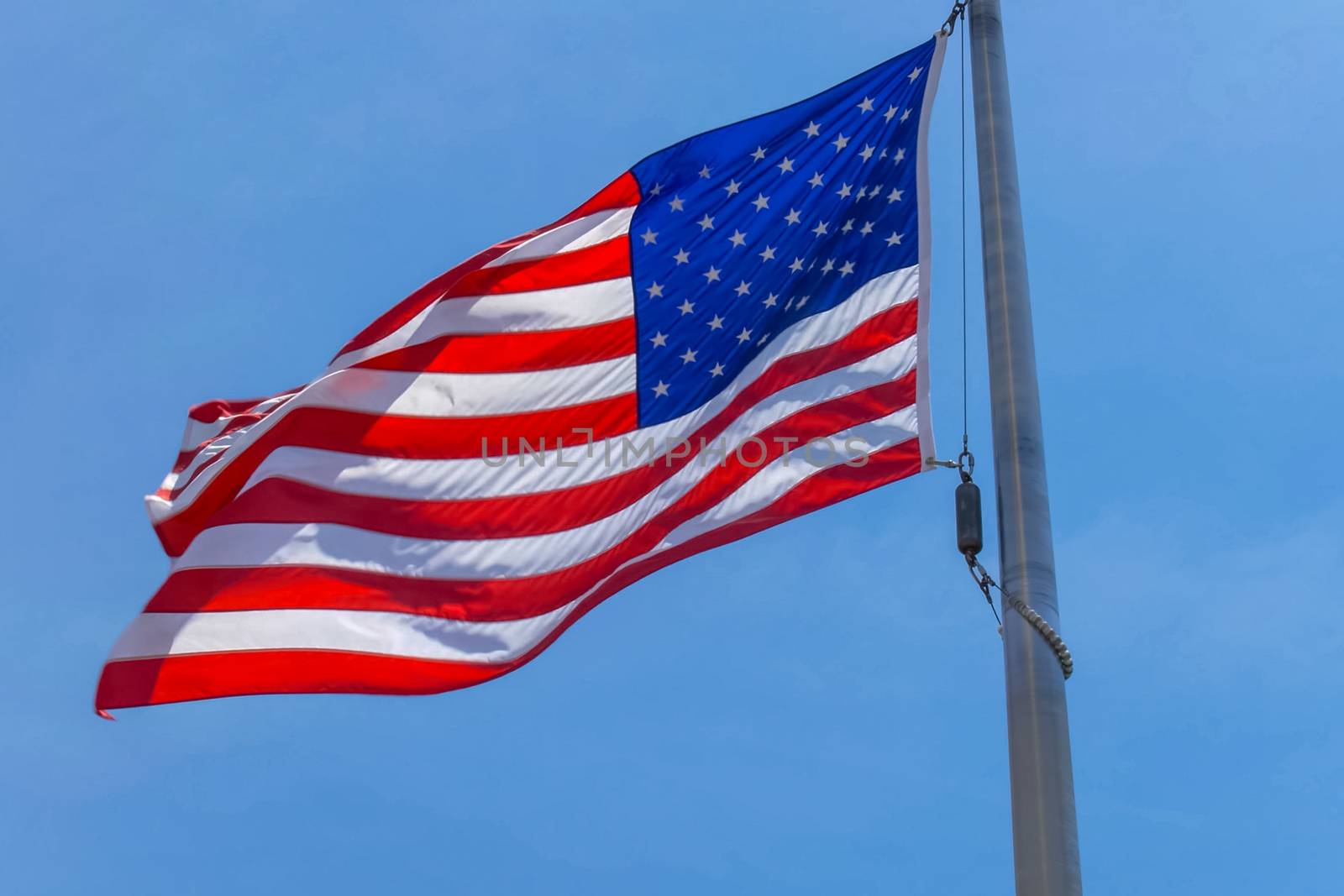 American flag on a pole. The flag flies by the wind by nyrok