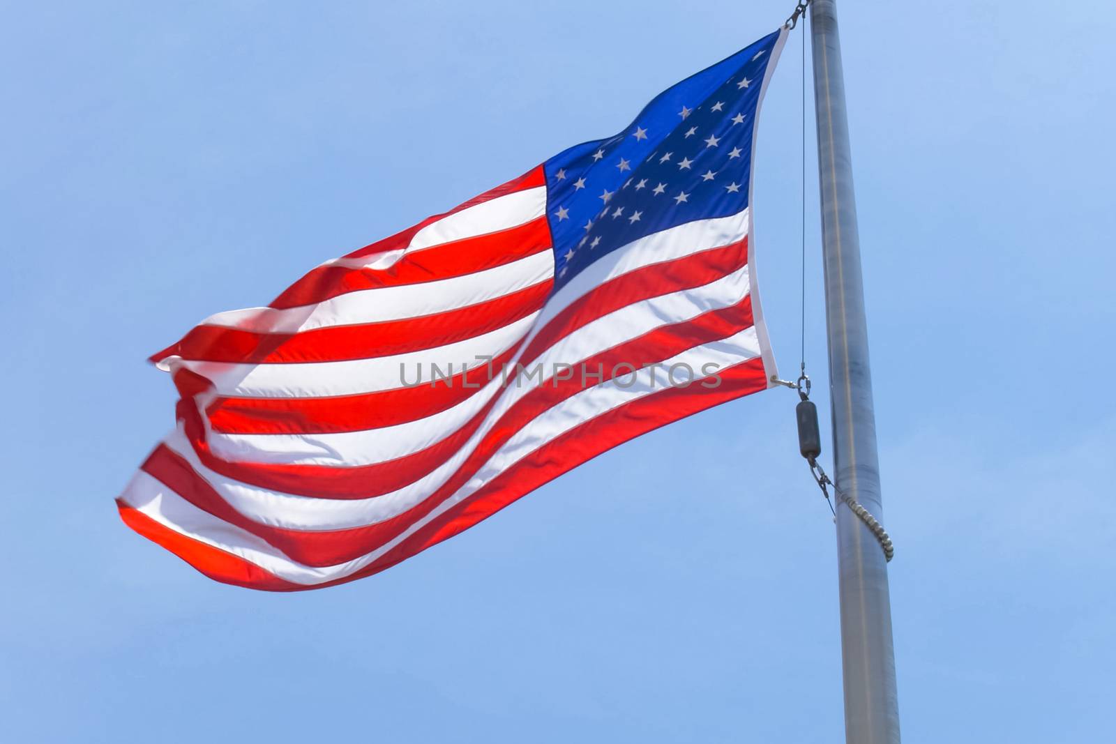 American flag on a pole. The flag flies by the wind by nyrok