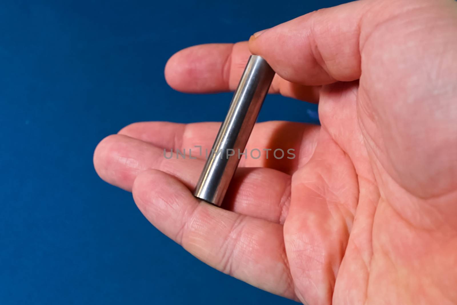 Tungsten rod in the hand. A piece of tungsten for experiments by nyrok