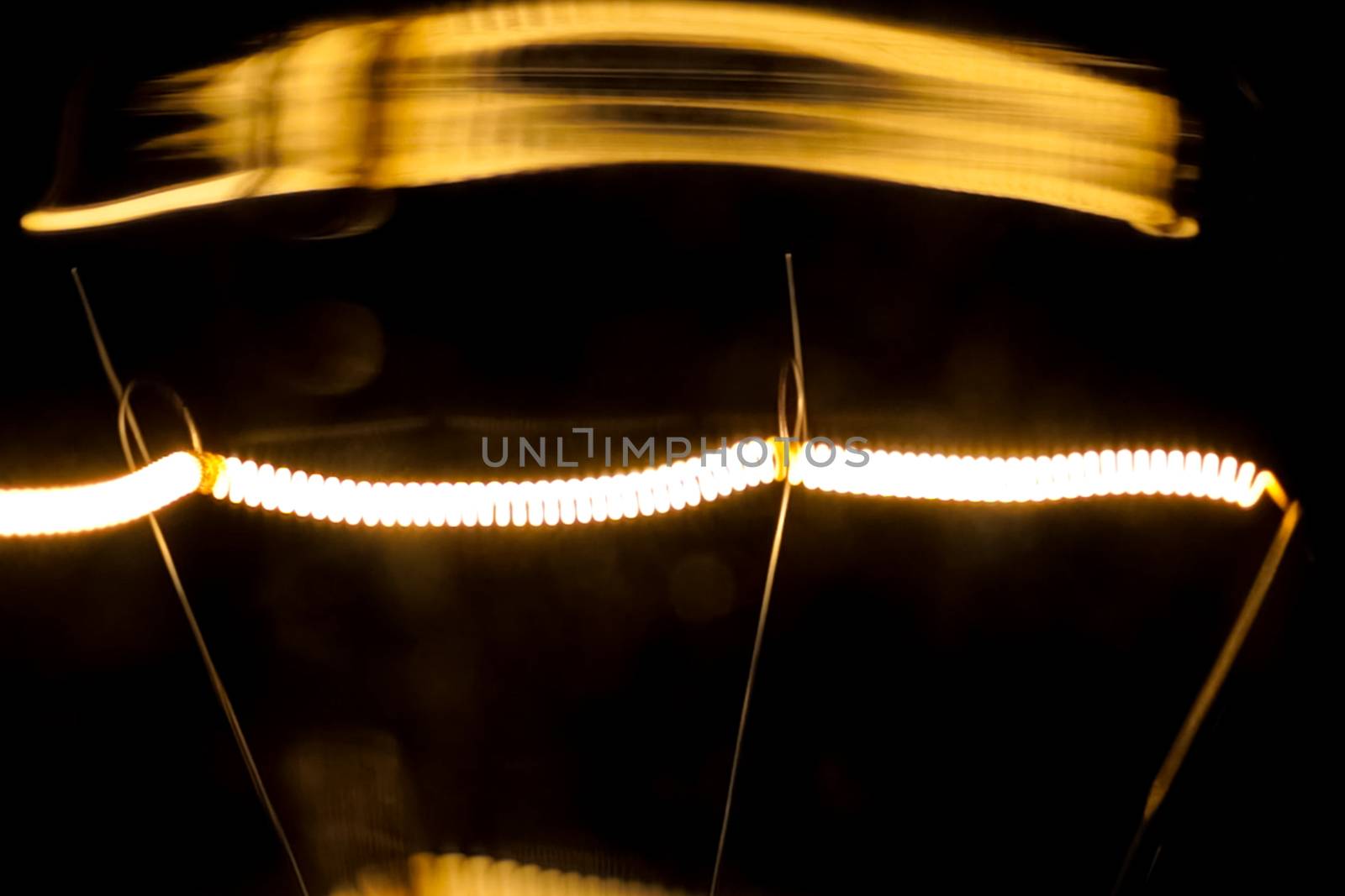 Tungsten filament in an incandescent lamp, macro photo