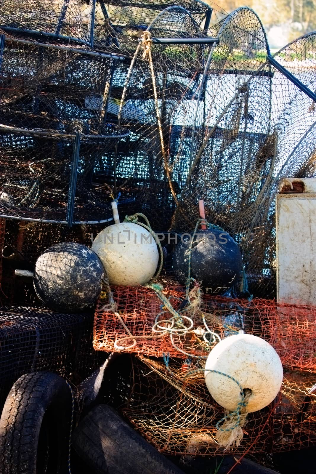 Vertical shot of nets, fish traps and buoys stored on shore