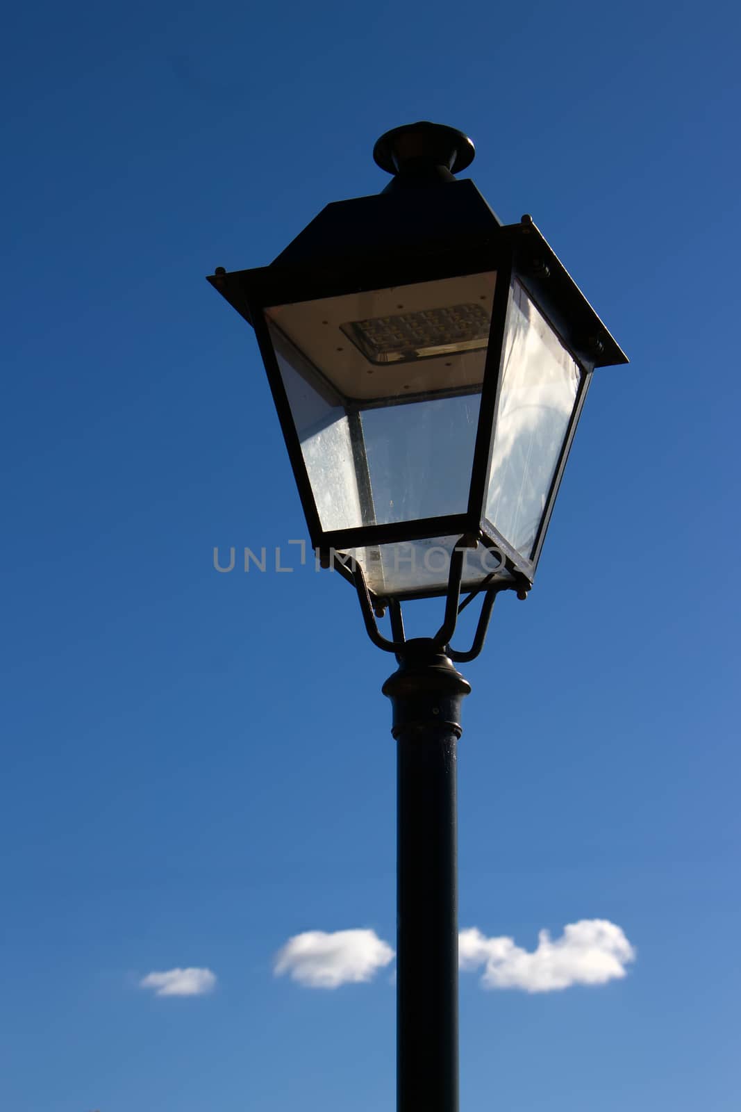 A vertical shot of an ornate street light by definitearts