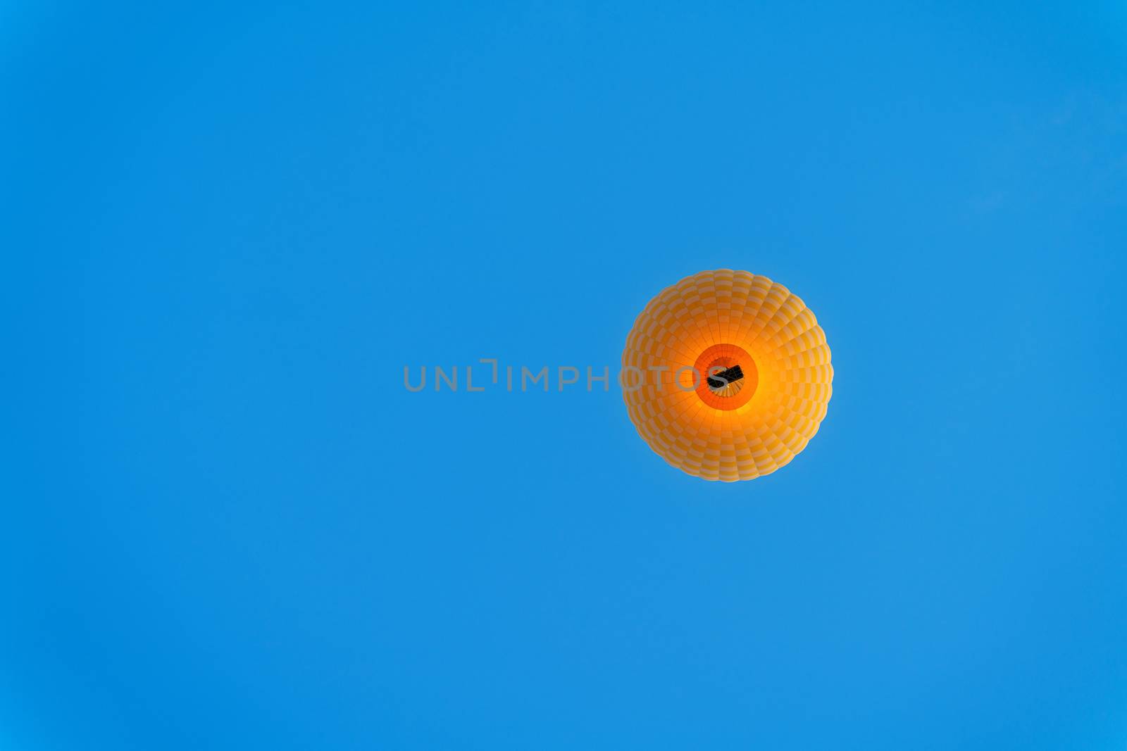 Yellow hot air balloon on blue sky. by gutarphotoghaphy