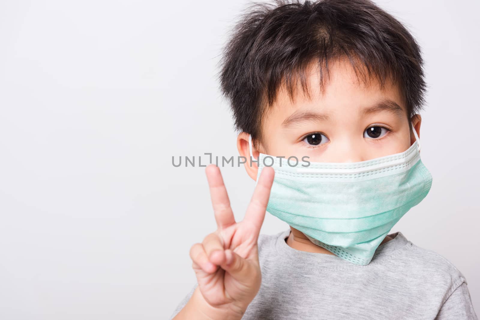 Closeup Asian face, Little children boy sick he using medicine healthcare mask on white background with copy space, health medical care