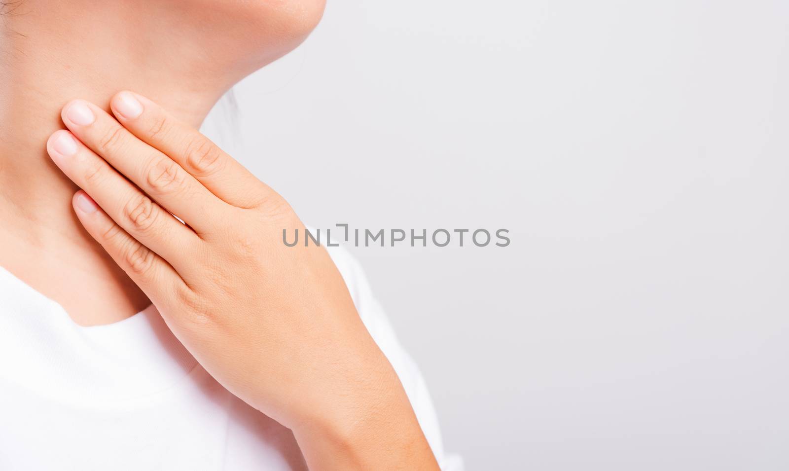 Asian beautiful woman Sore Throat or thyroid gland problem her useing Hand Touching Ill Neck on white background with copy space, Medical and Healthcare concept