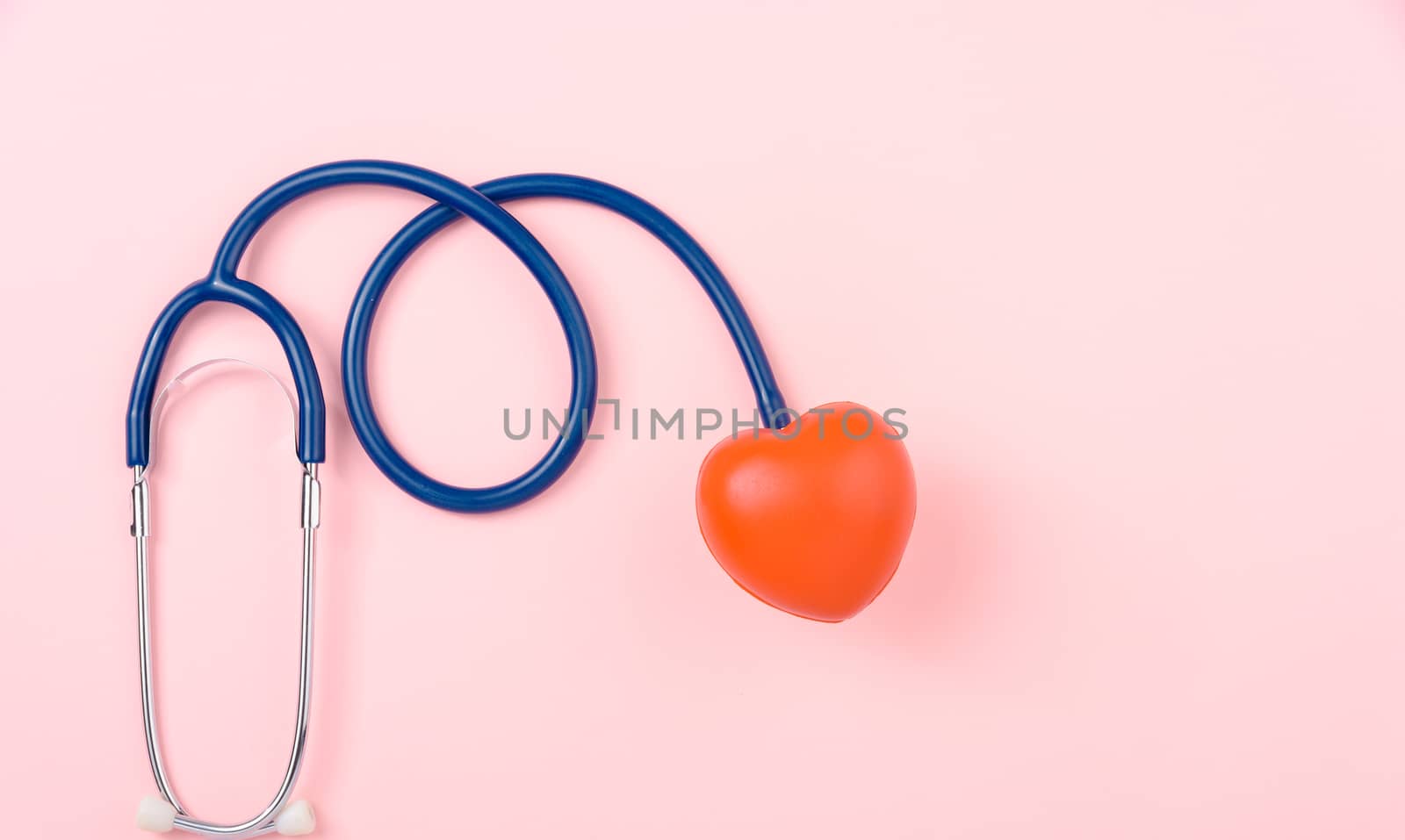 World health day concept, Stethoscope, globe and red heart on pink background with copy space. Global health care