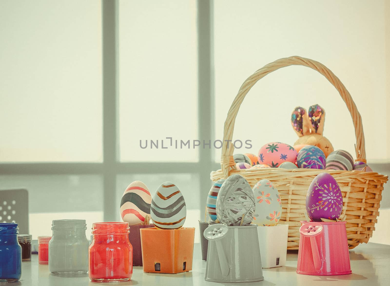 Easter eggs that are painted and decorated are placed in a basket to prepare to celebrate Easter.