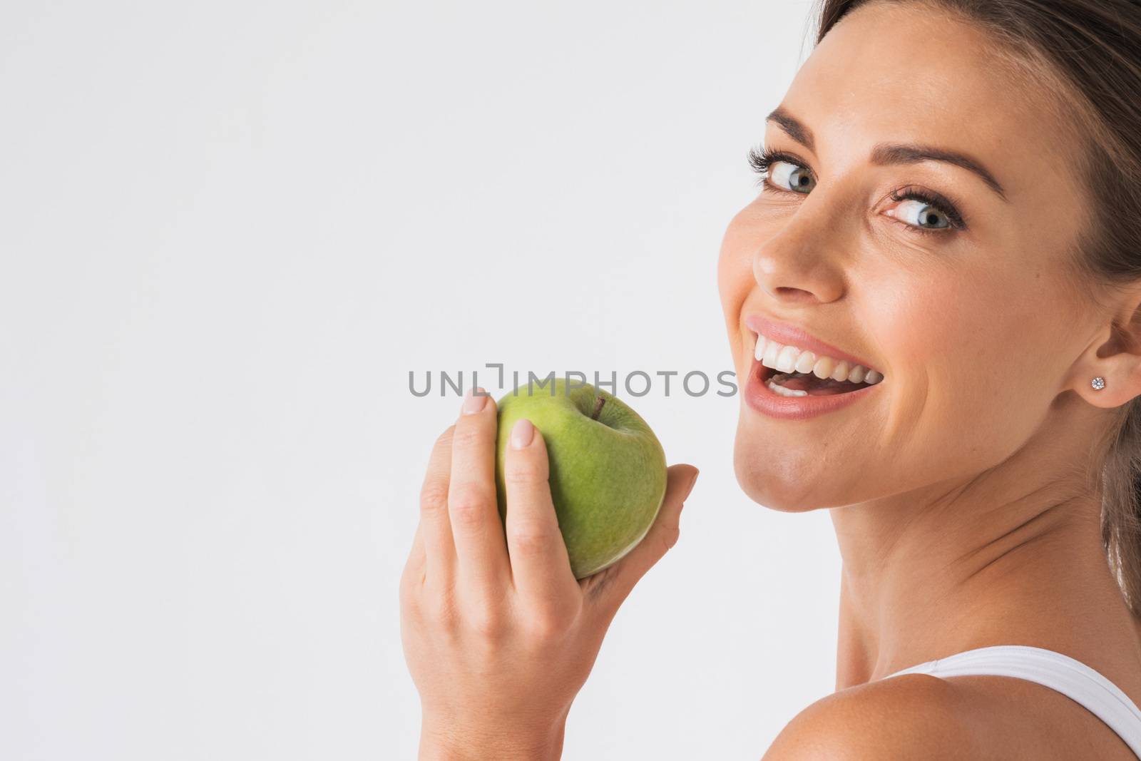 Young beauty woman with green apple on white background