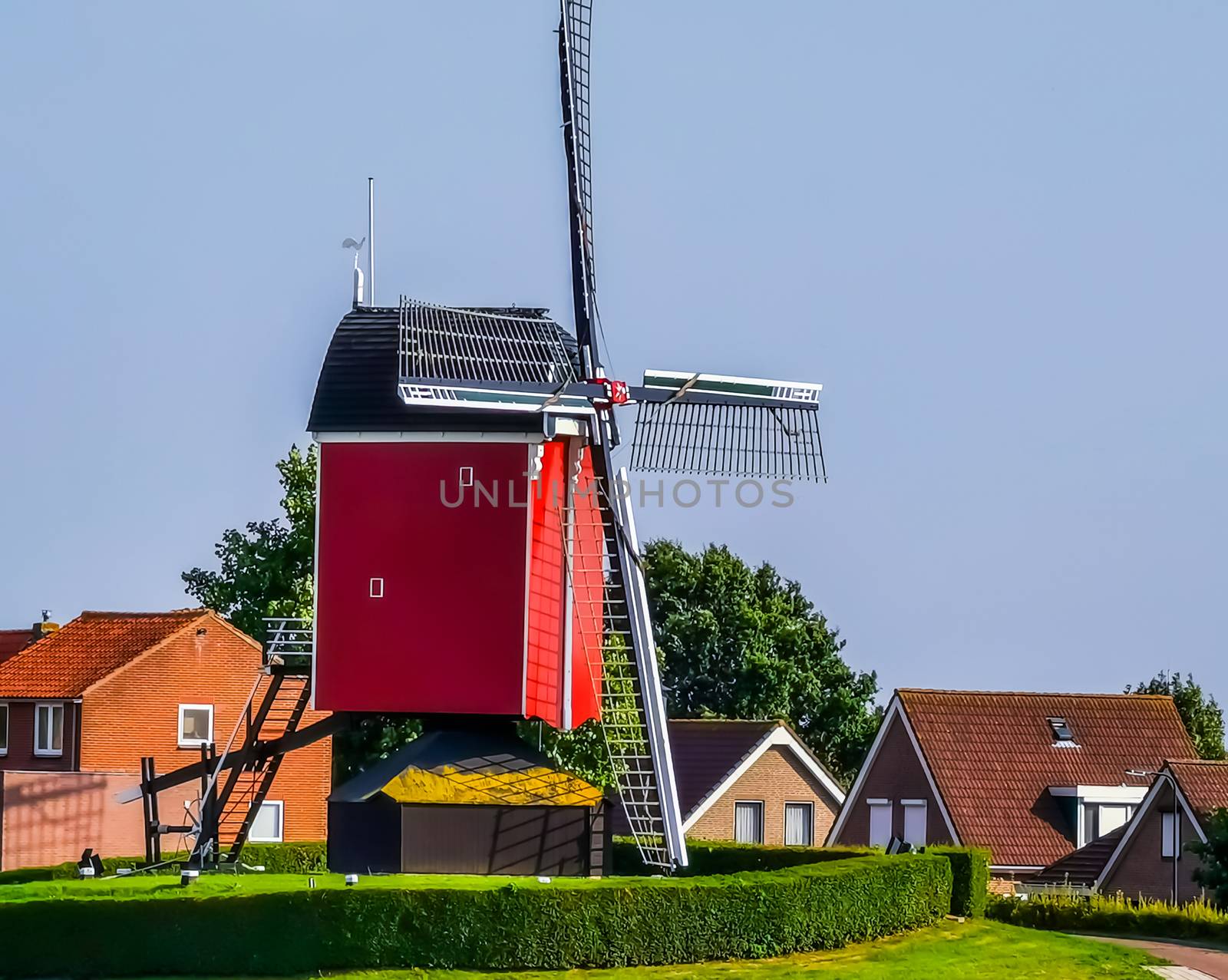 the windmill of sint annaland with the village in the background, touristic town in zeeland, The Netherlands
