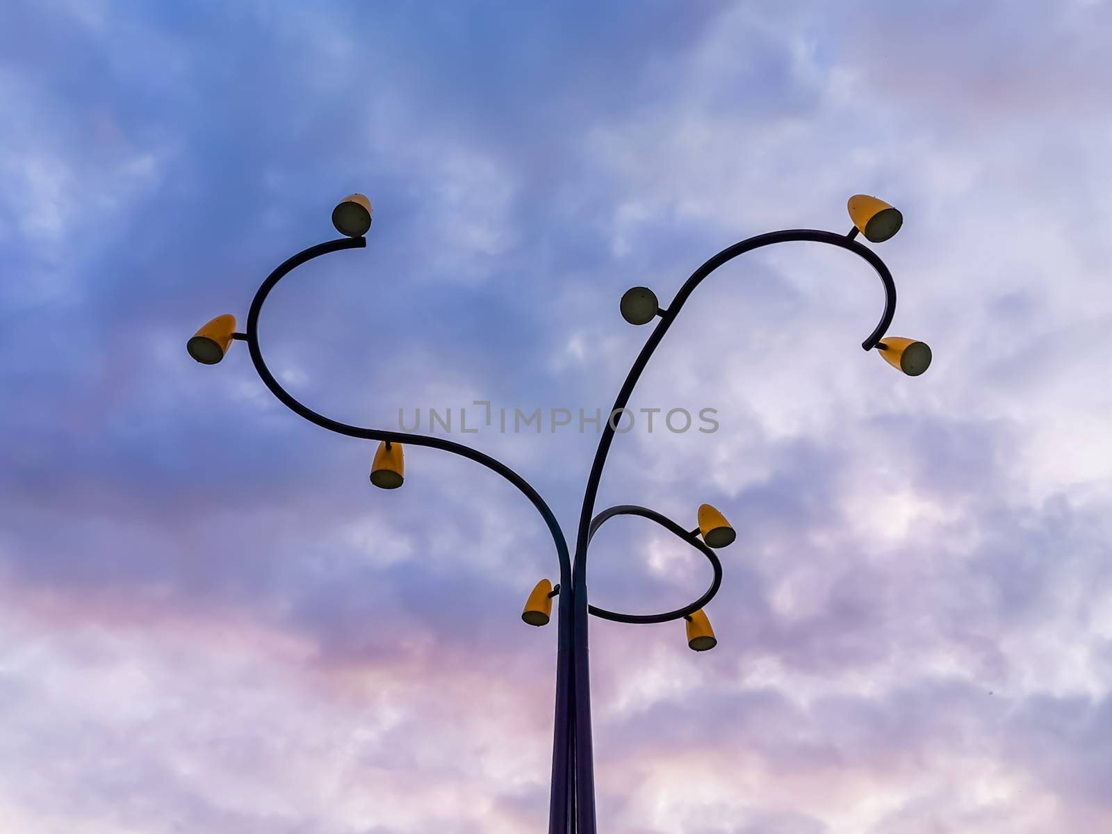 Beautiful modern lamppost artwork with colorful sky, village architecture of Sint Annaland, Zeeland, The Netherlands