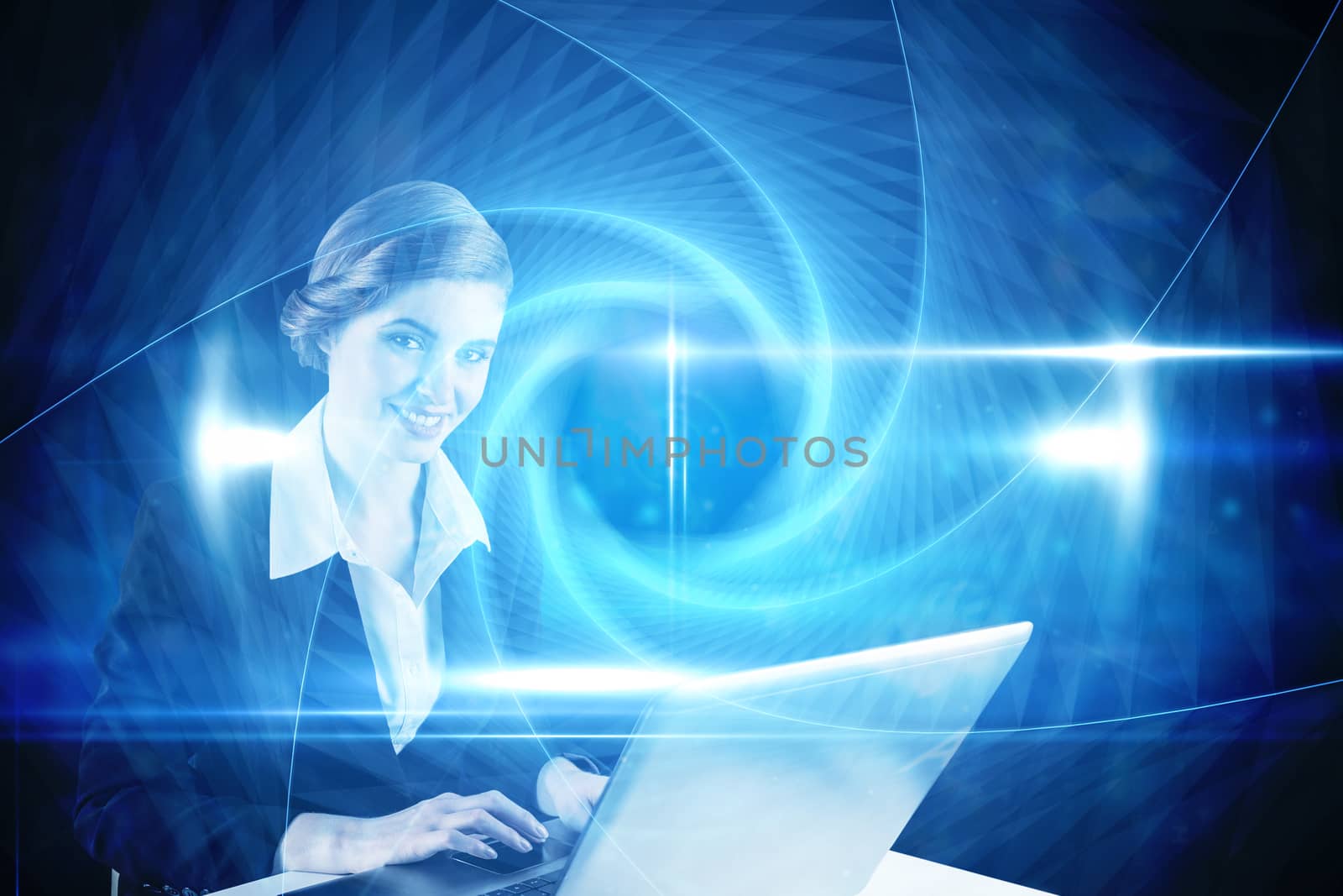 Composite image of redhead businesswoman using her laptop by Wavebreakmedia