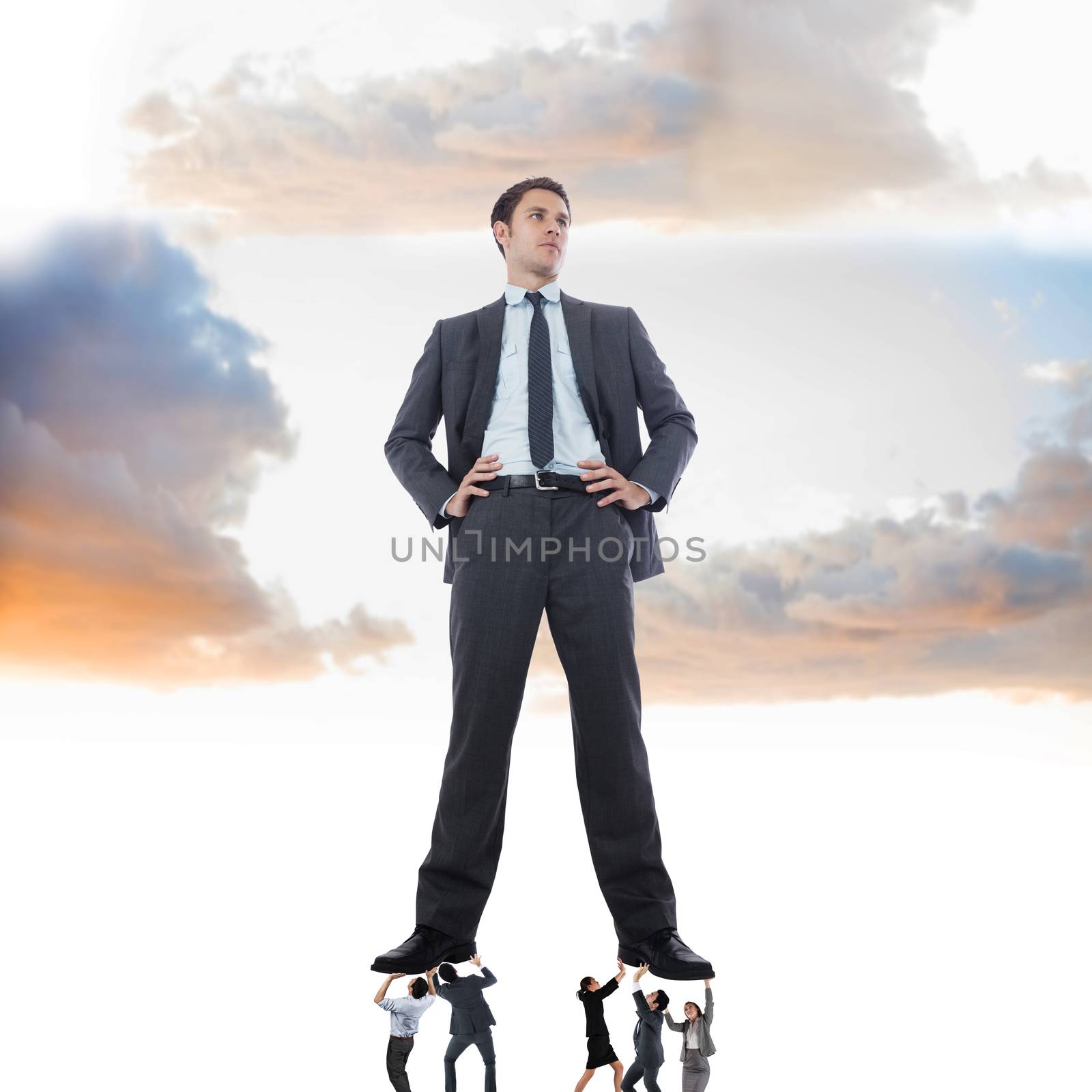 Composite image of business team supporting boss against heavenly sky