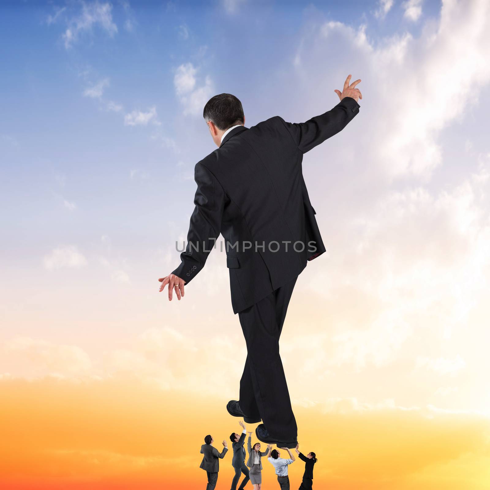 Composite image of business team supporting boss by Wavebreakmedia