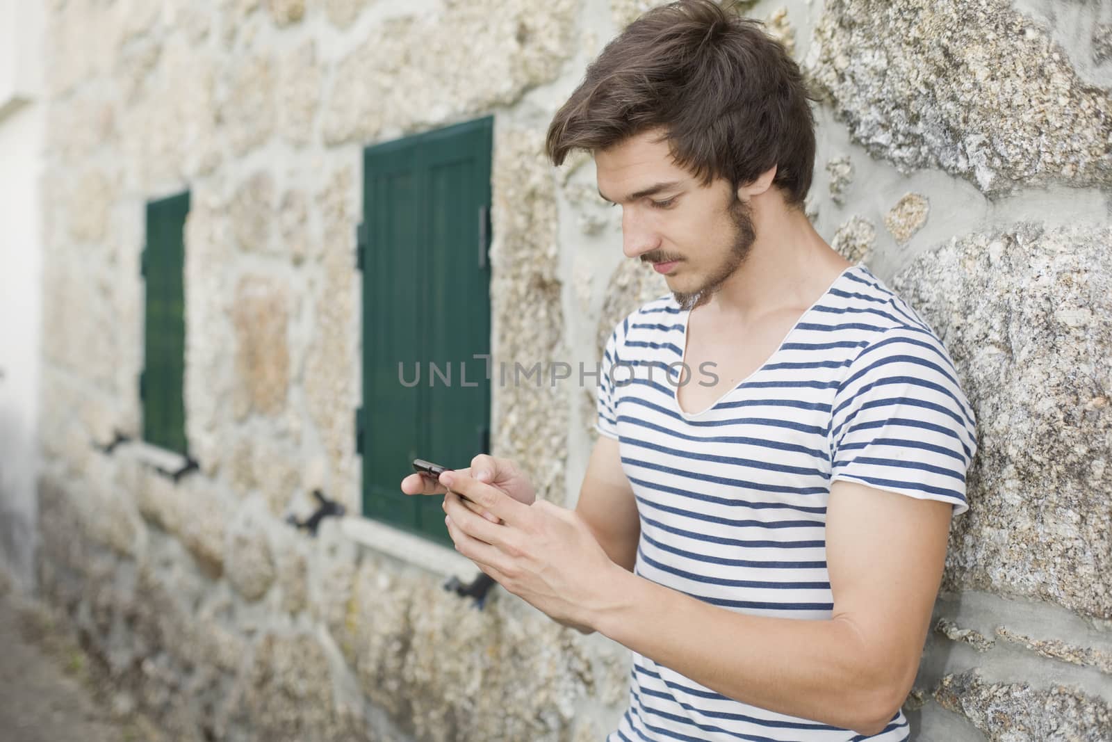 young casual man on the phone, outdoor