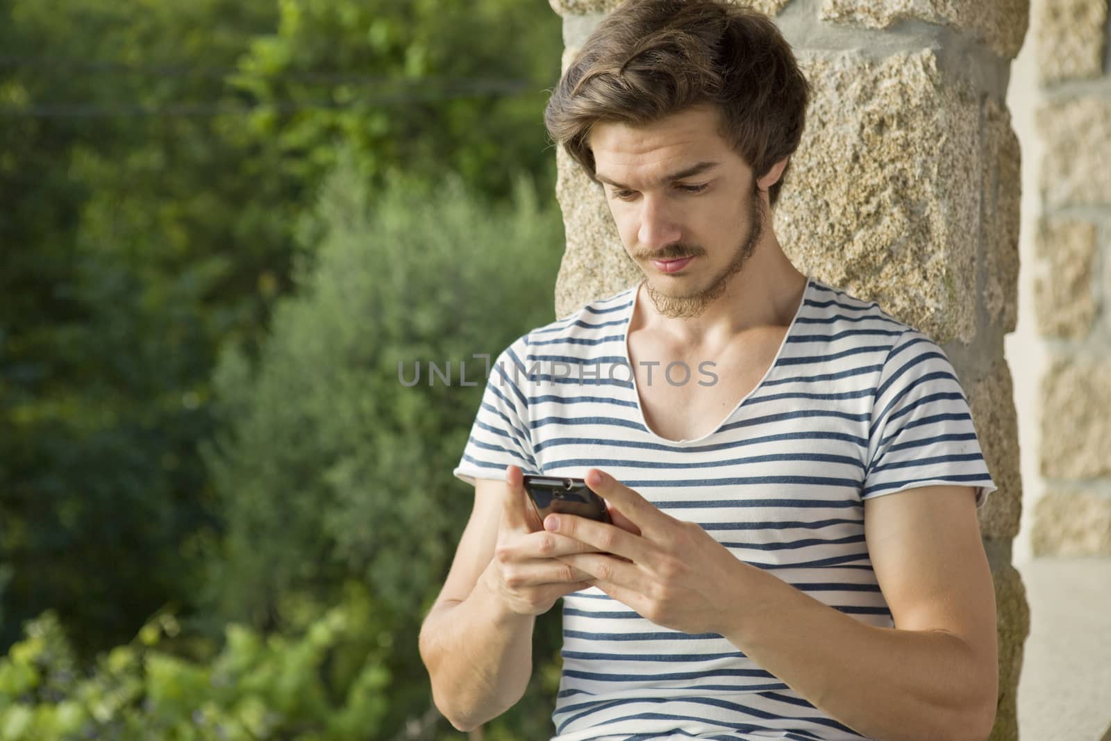 young casual man on the phone, outdoor