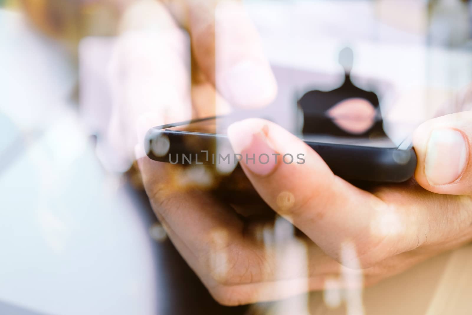 Hands with mobile, double exposure