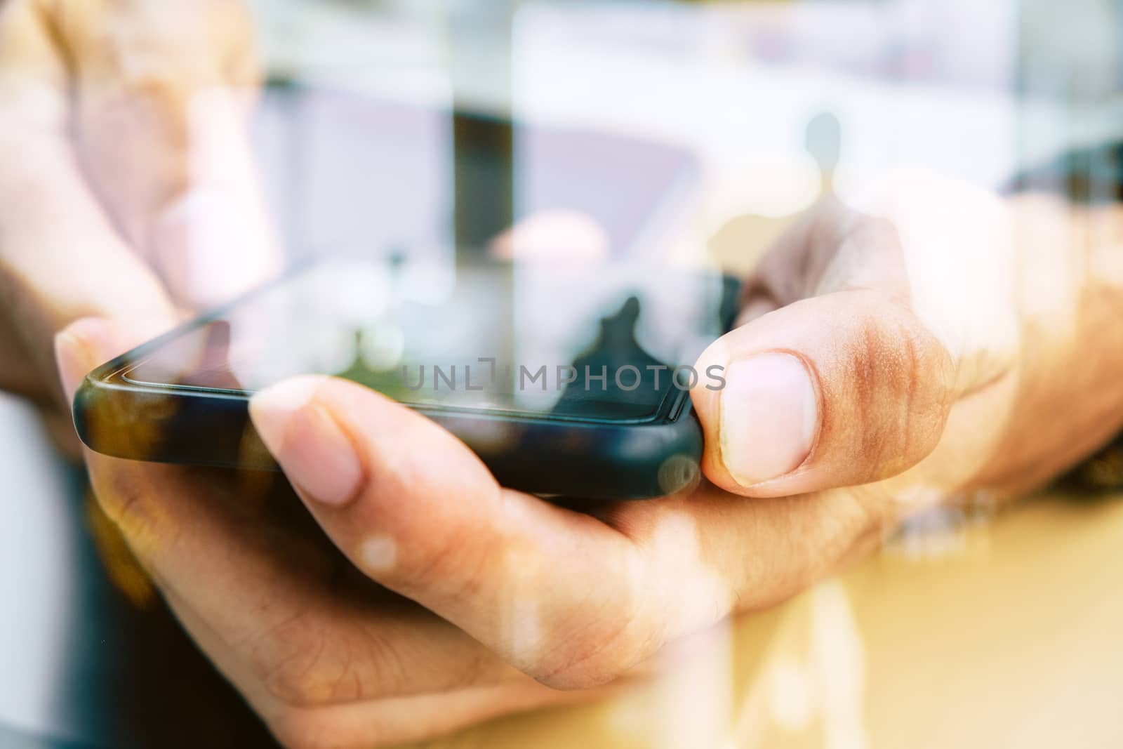 Hands with mobile, double exposure