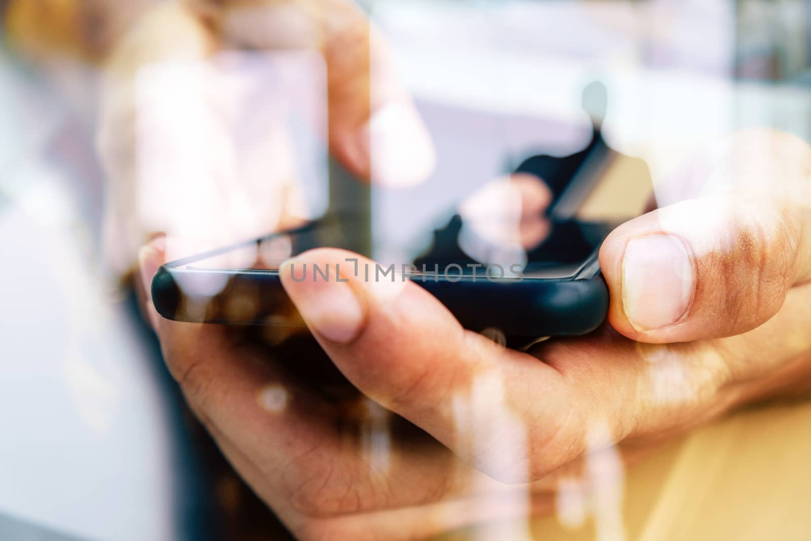 Hands with mobile, double exposure