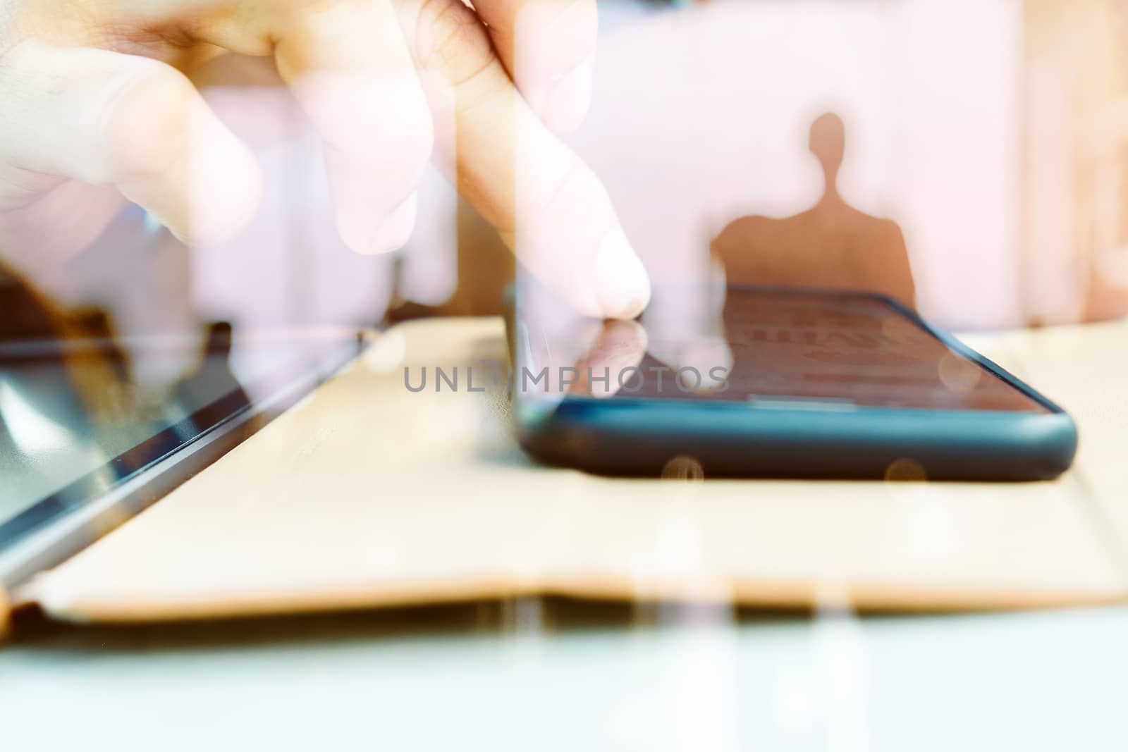 Hands with mobile, double exposure