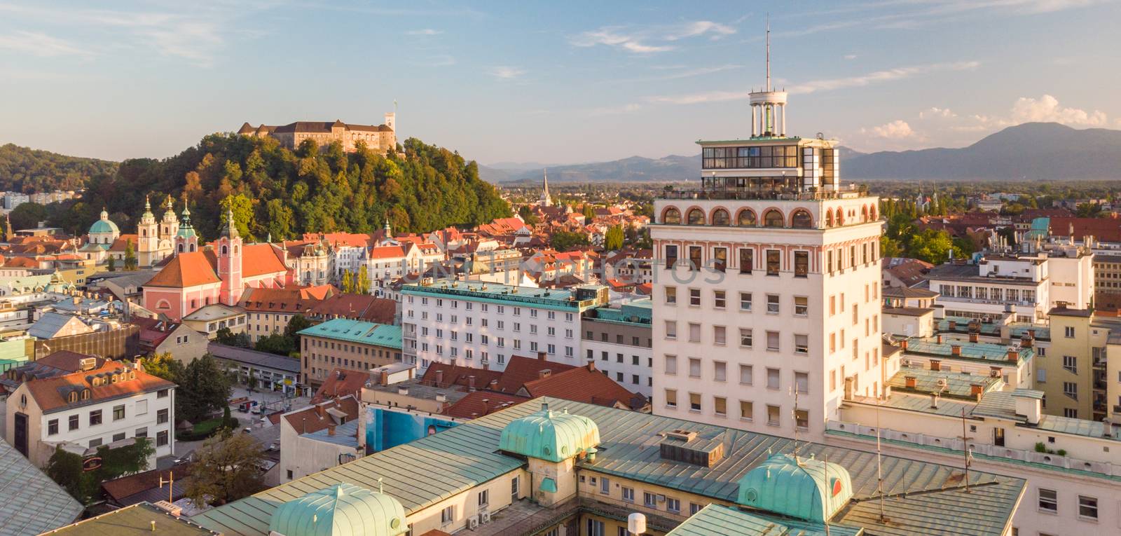 Cityscape of Ljubljana, capital of Slovenia, and it's old skyscraper in warm afternoon sun. by kasto