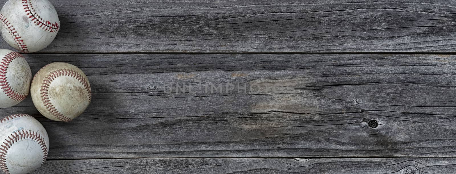 Old used baseballs on vintage wooden background. Baseball sports concept with copy space