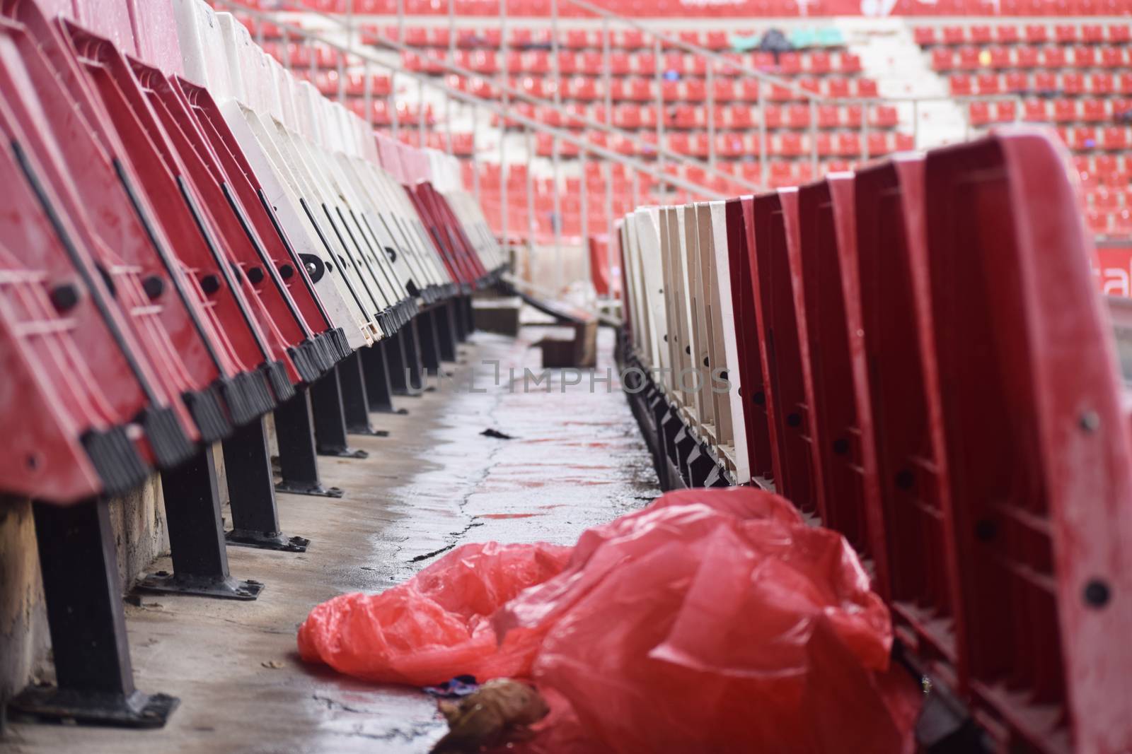Red and white stadium seats after a match in Girona