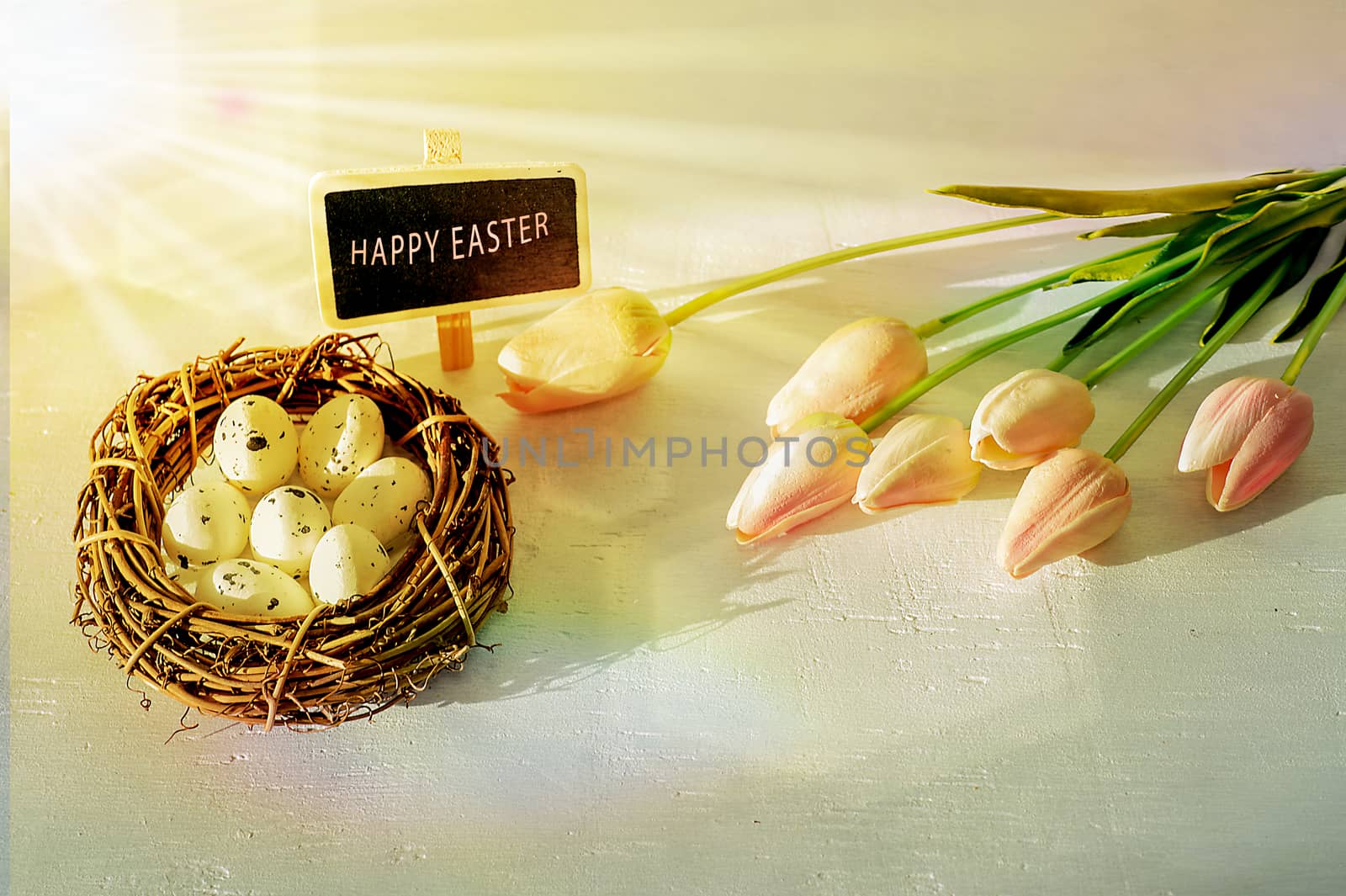 Easter eggs and tulips on wooden planks.