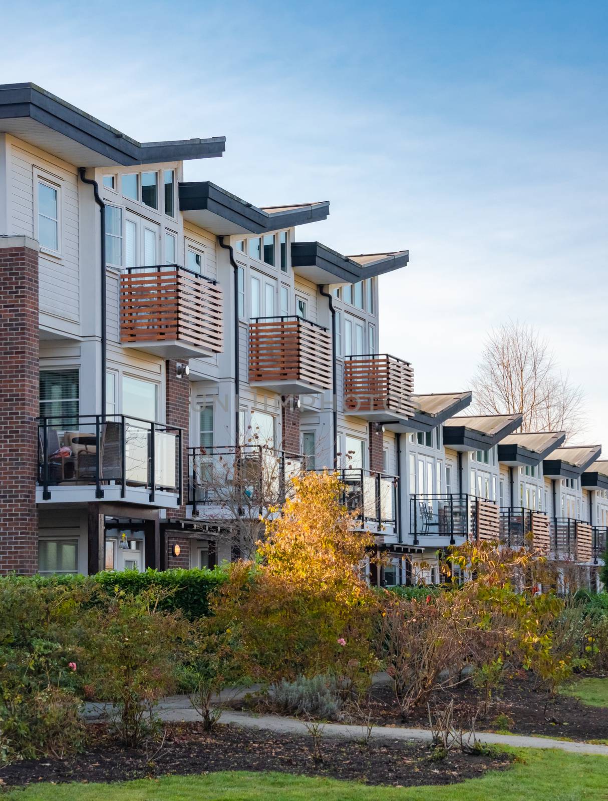 Row of residential townhouses on winter day in British Columbia. by Imagenet