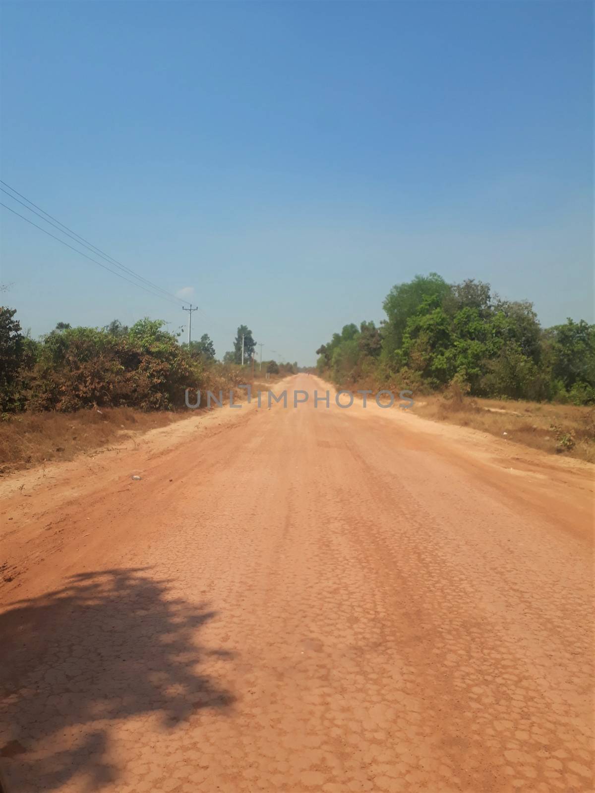 A dirt road in cambodia, asia. Red soil